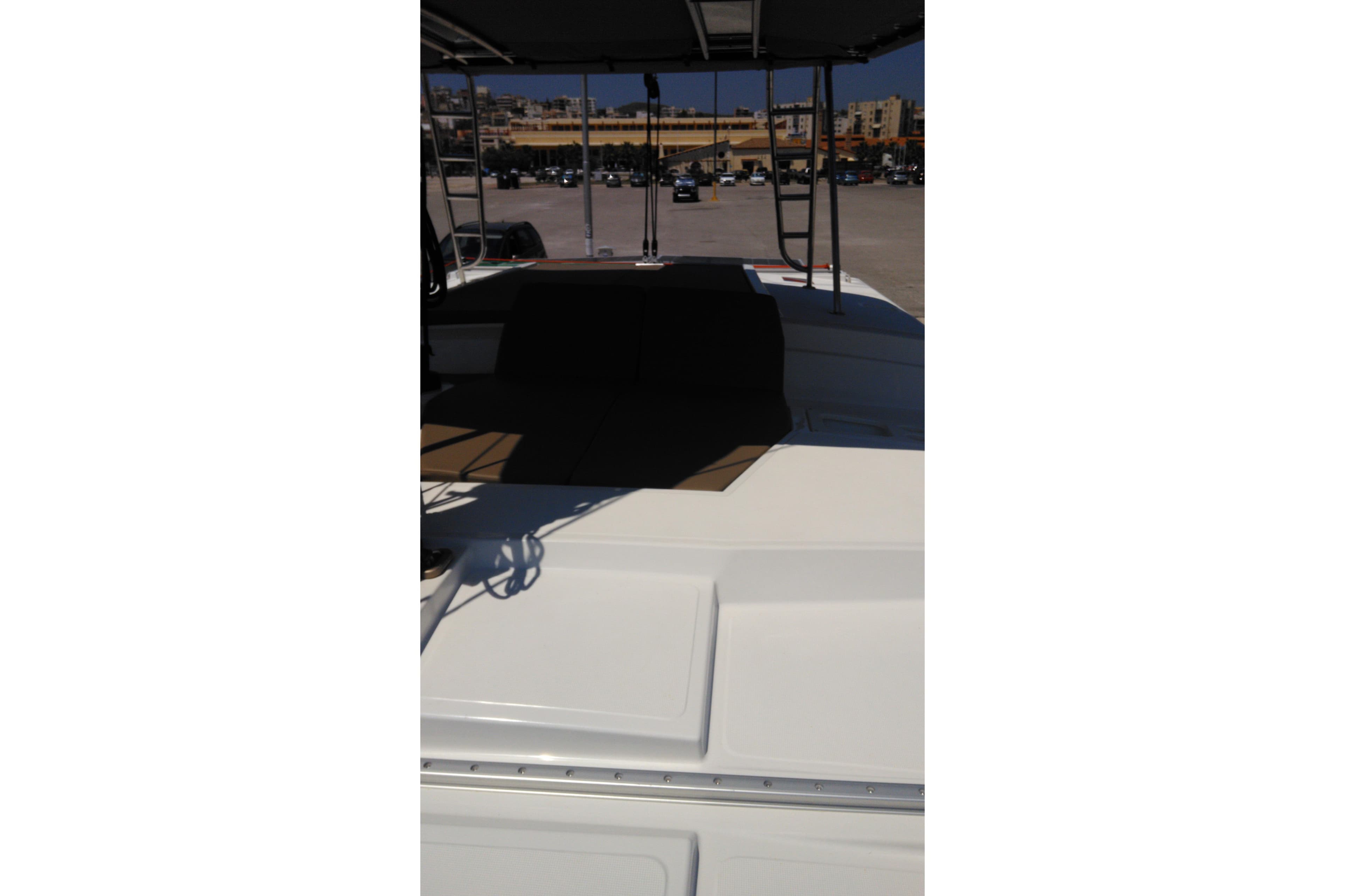 2018 Bali 4.1 catamaran deck with seating area, parked in a marina.