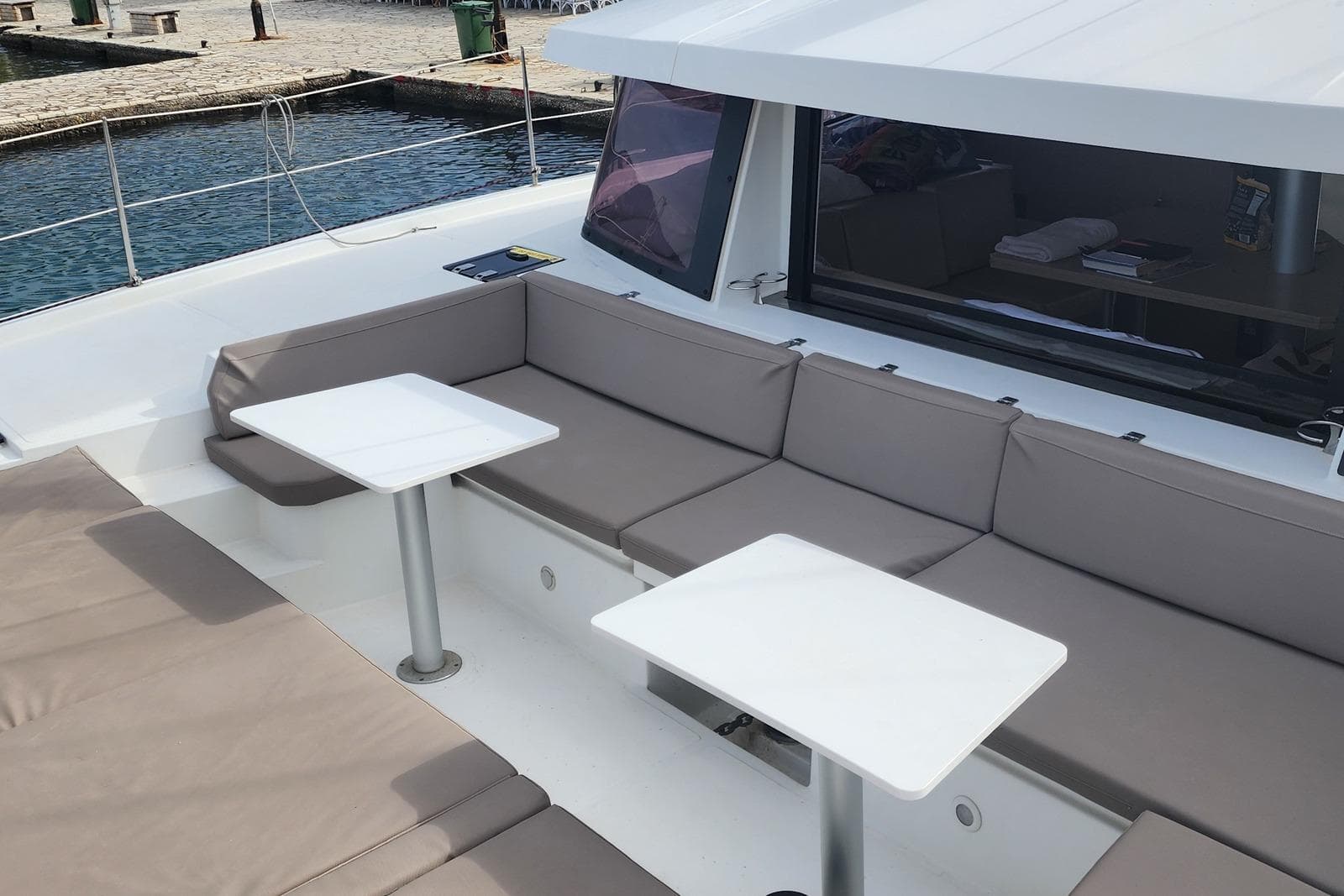Luxurious seating area on a 2016 Bali 4.5 catamaran, featuring comfortable cushions and tables.