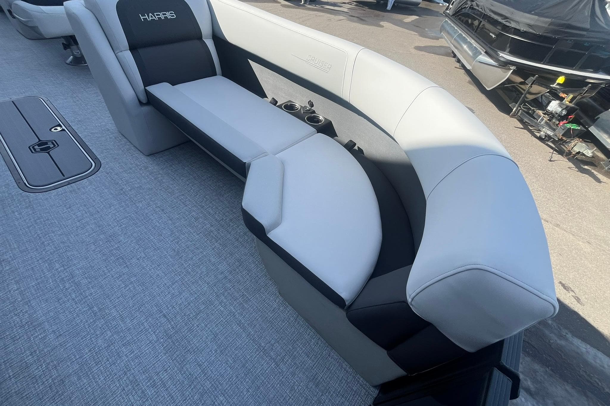 2026 Harris Cruiser 230 CWDH boat interior with plush seating and cup holders.