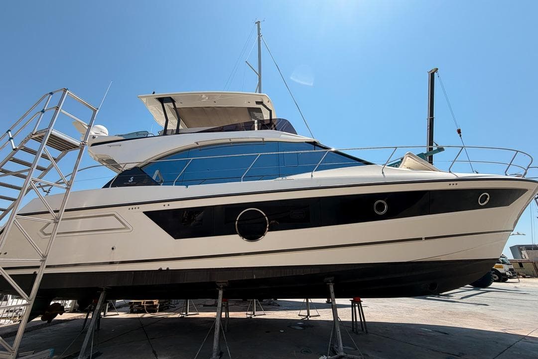 2022 Beneteau Monte Carlo 52 yacht on dry dock under clear blue sky.