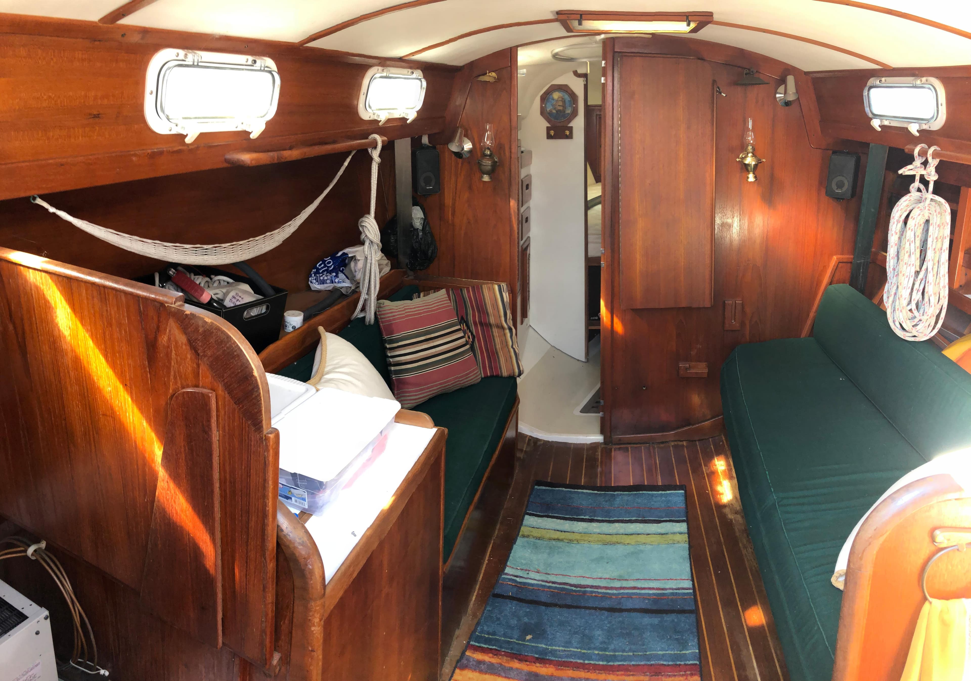 Interior of 1980 Tartan 33 sailboat with wooden furnishings and cozy seating.