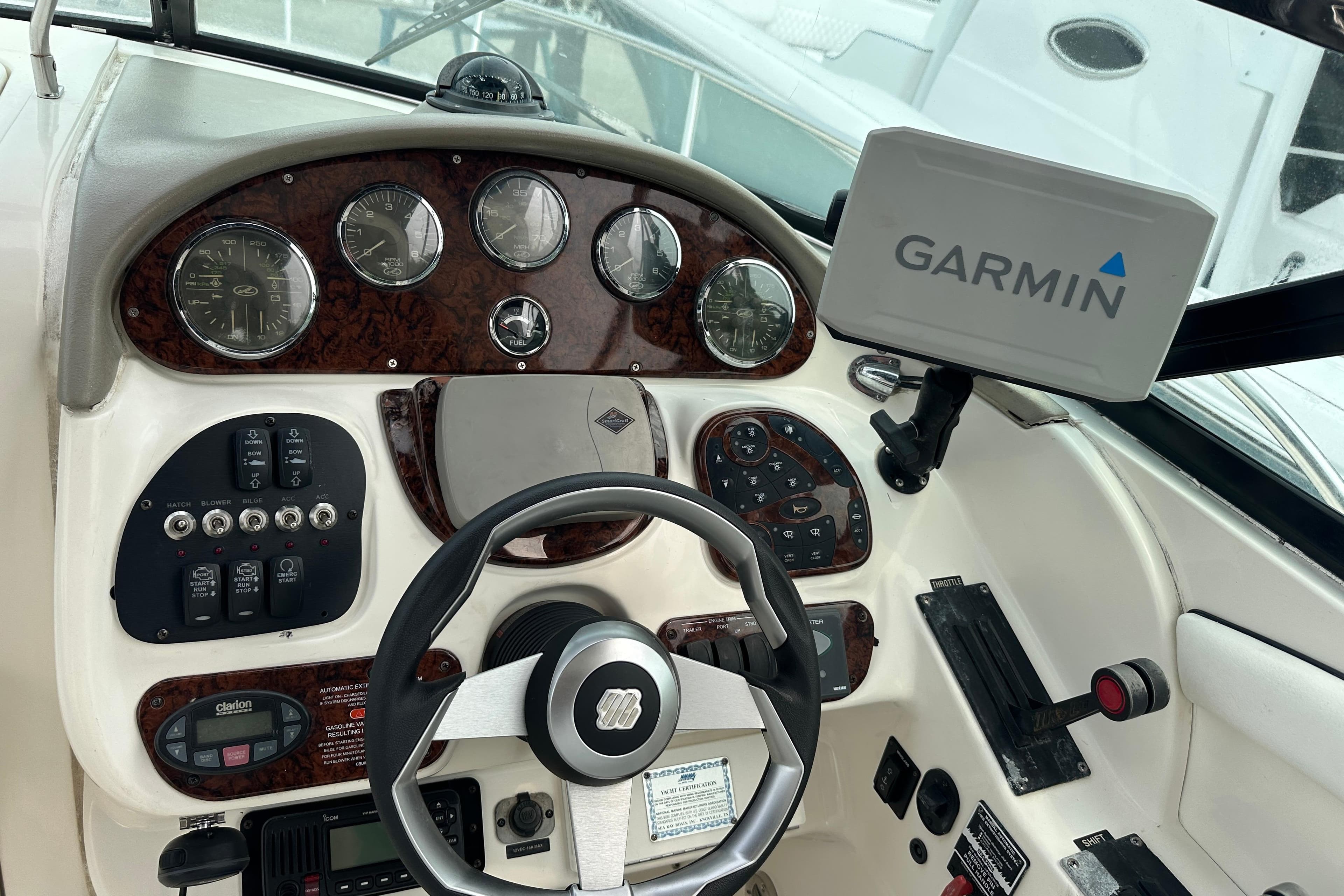 Helm of 2005 Sea Ray 290 SLX with Garmin navigation system and classic gauges.