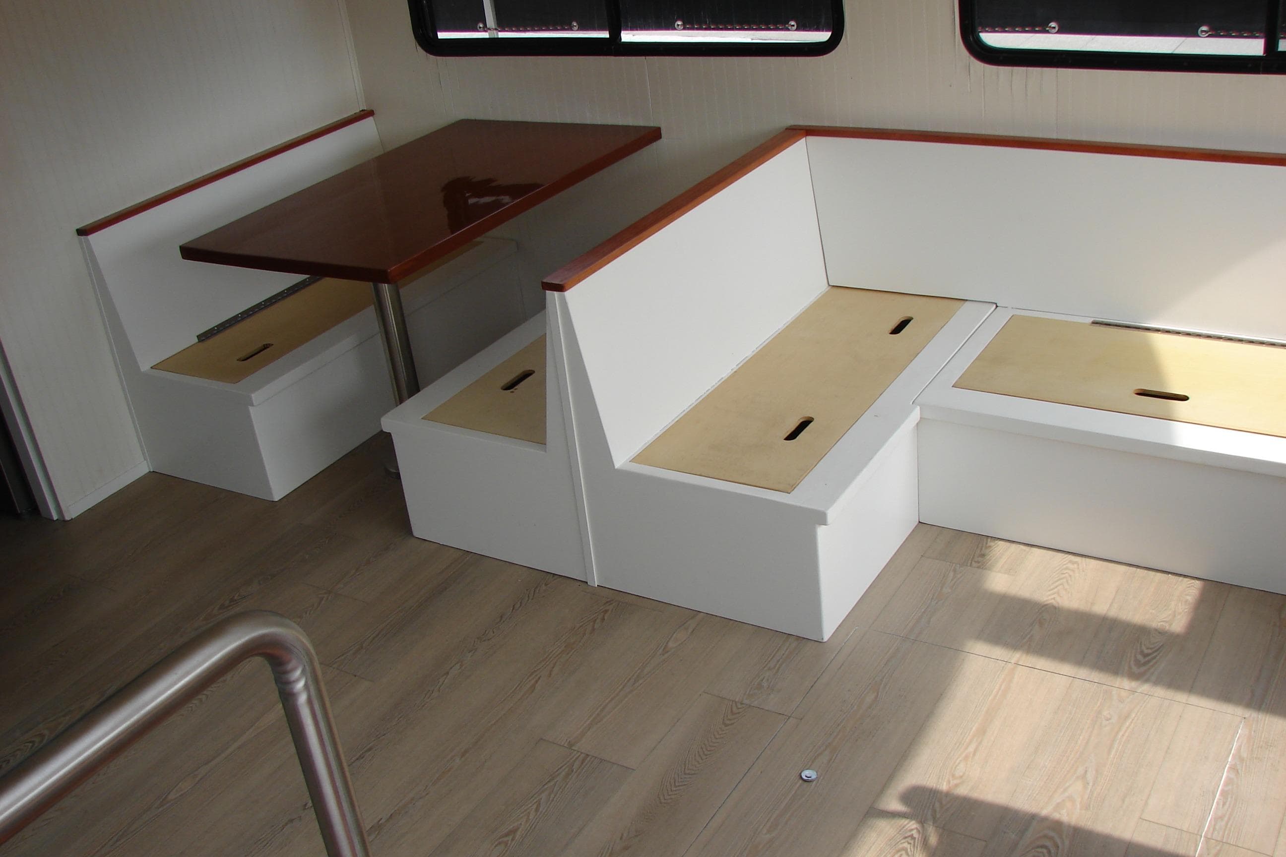 Interior of 1997 Gibson 47 Sport Houseboat with wooden table and seating.