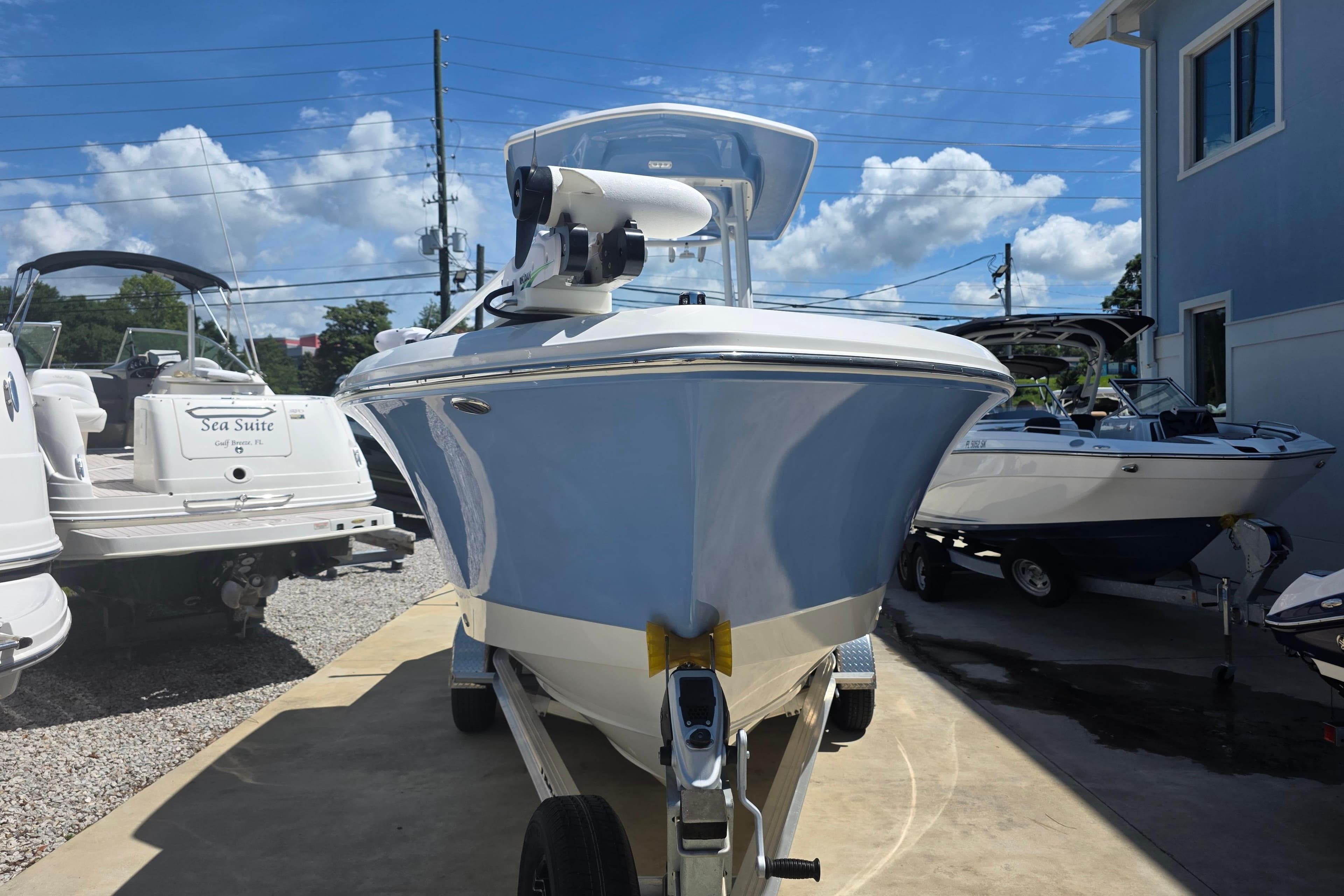 2022 Robalo R230 Center Console boat on trailer under clear blue sky.