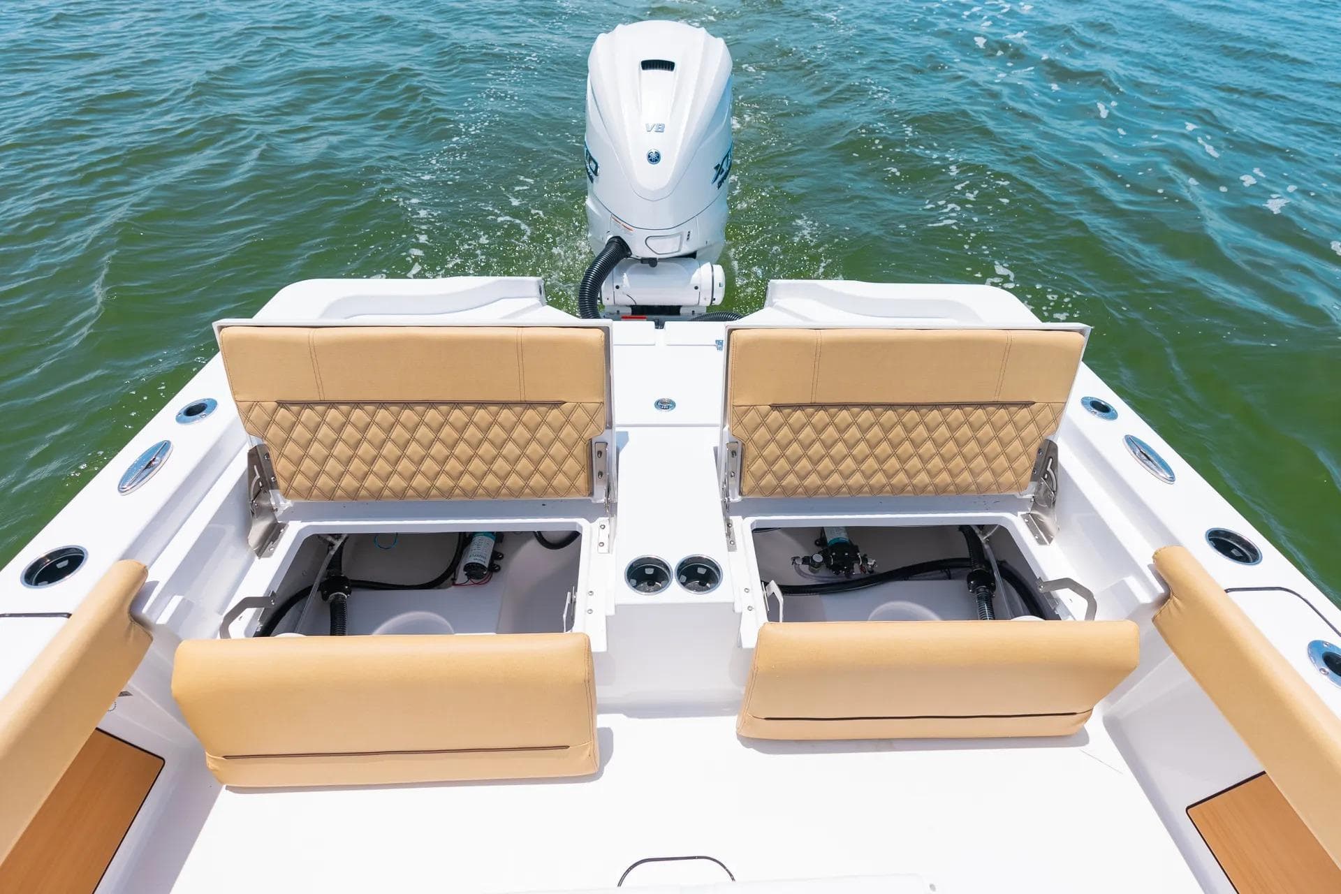 2026 Sportsman Masters 267 Bay Boat with tan seating and outboard motor on water.