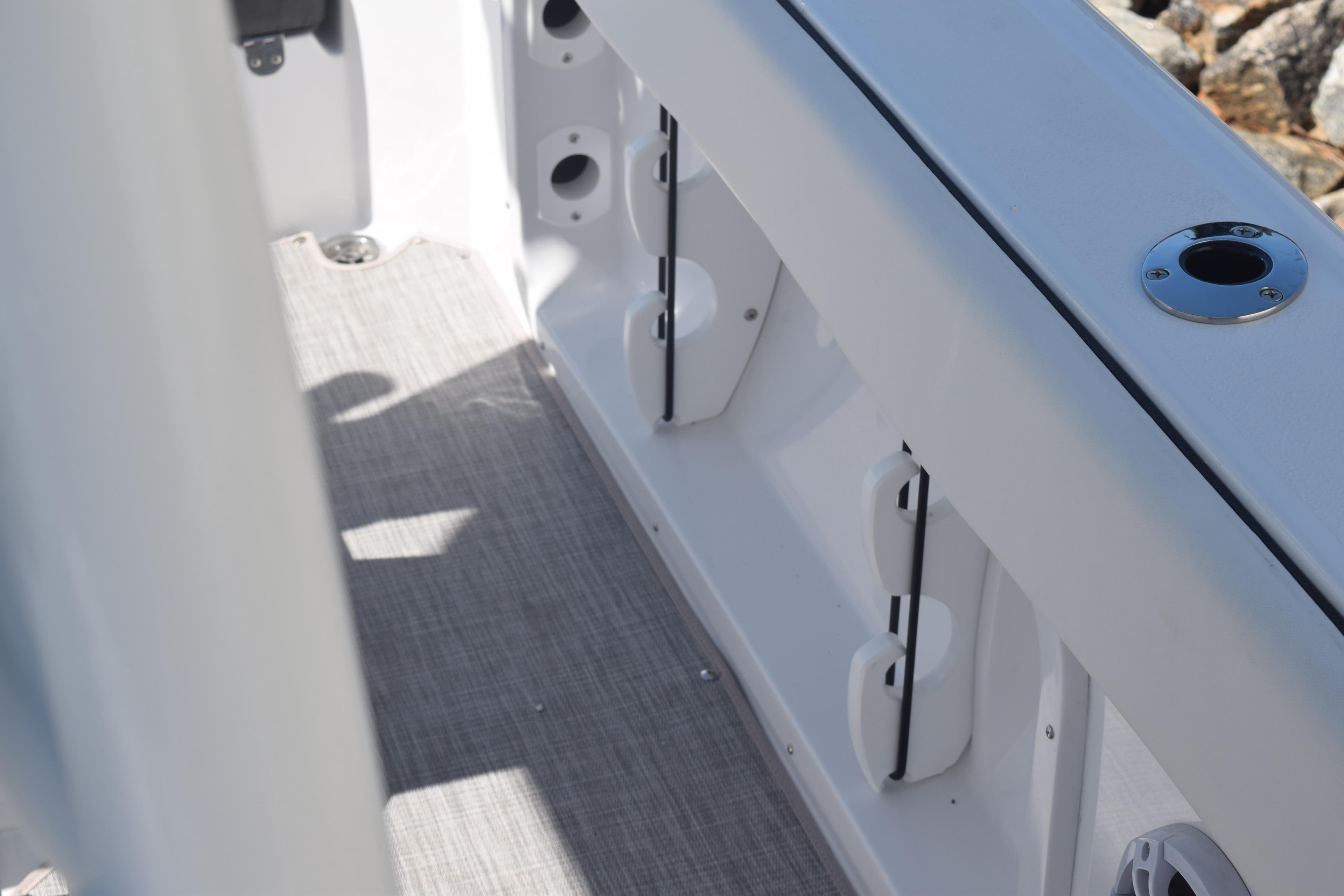 2025 Stingray 216CC boat interior with rod holders and sleek design.