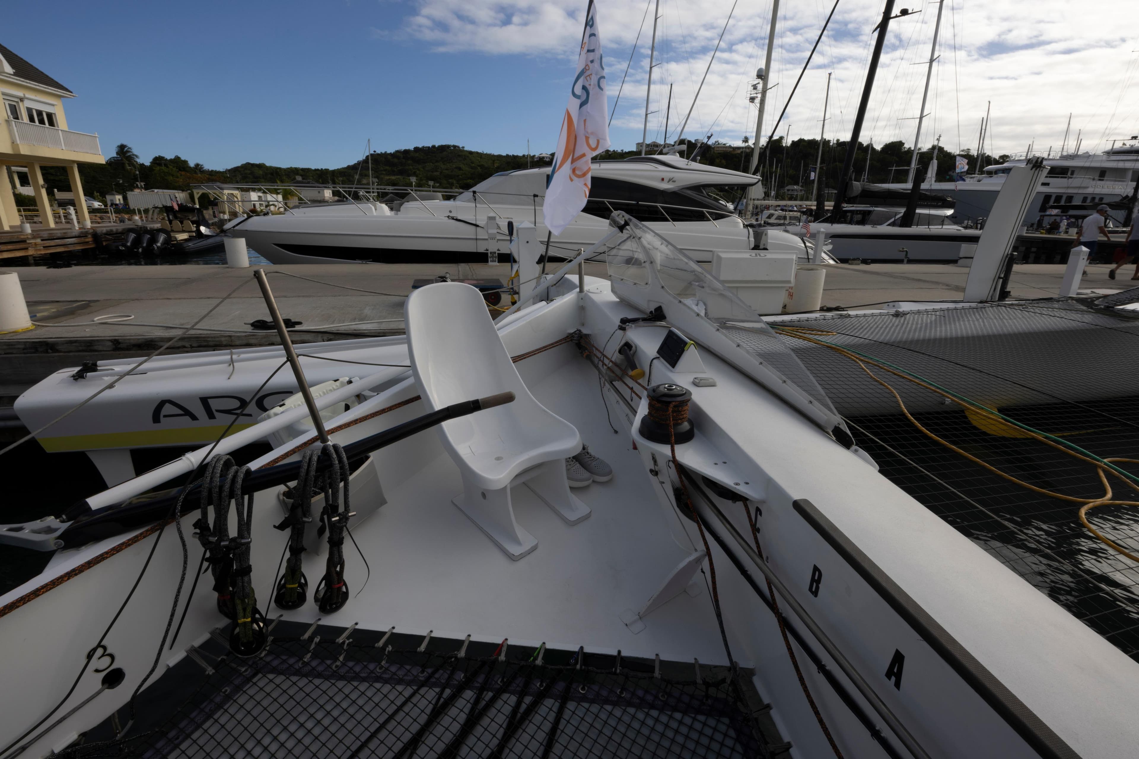 Sailing yacht CDK Technologies MOD 70, 2012, docked at marina with clear sky.