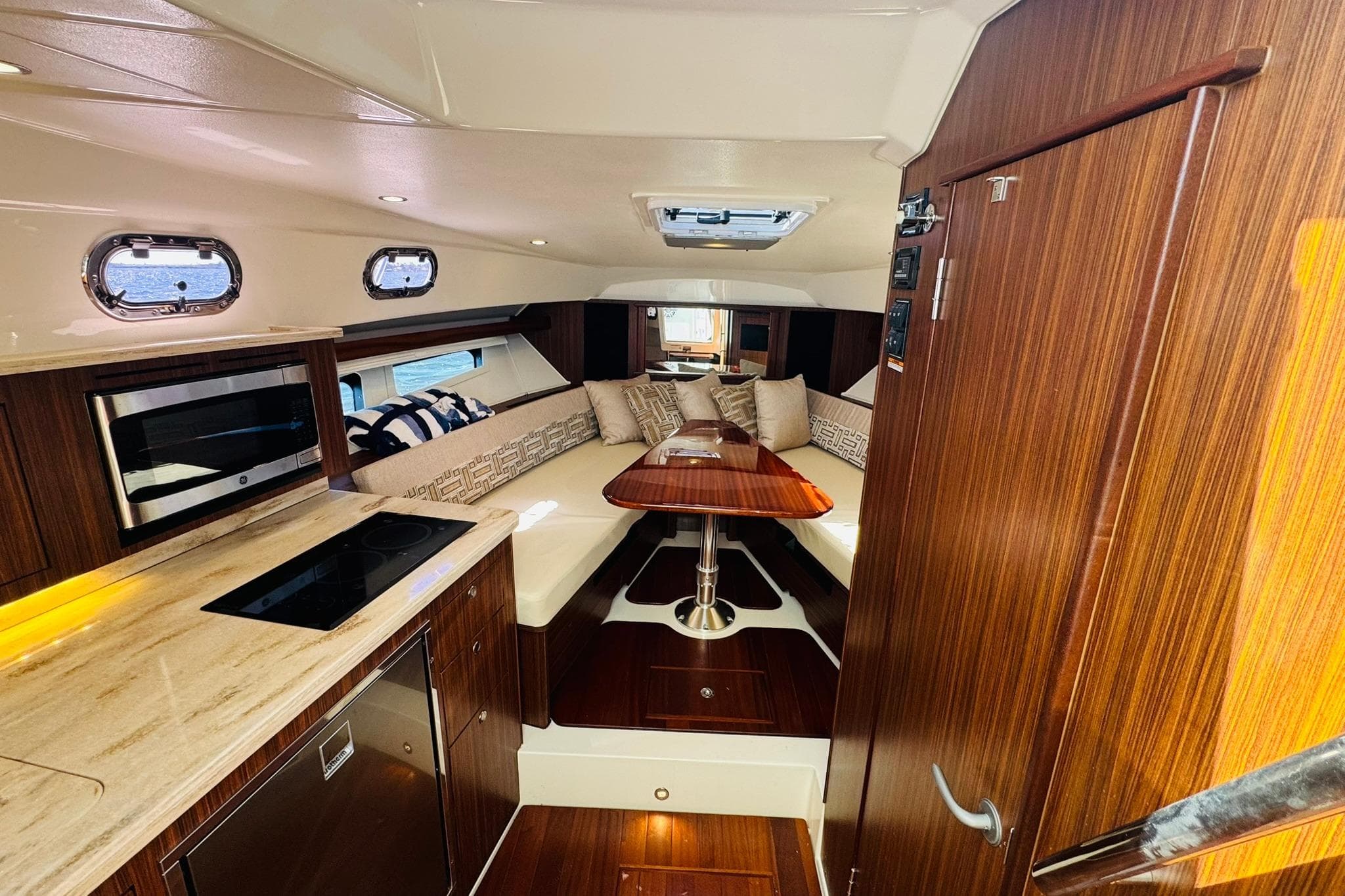 Interior of 2021 Pursuit OS 355 Offshore yacht with modern kitchen and cozy seating area.