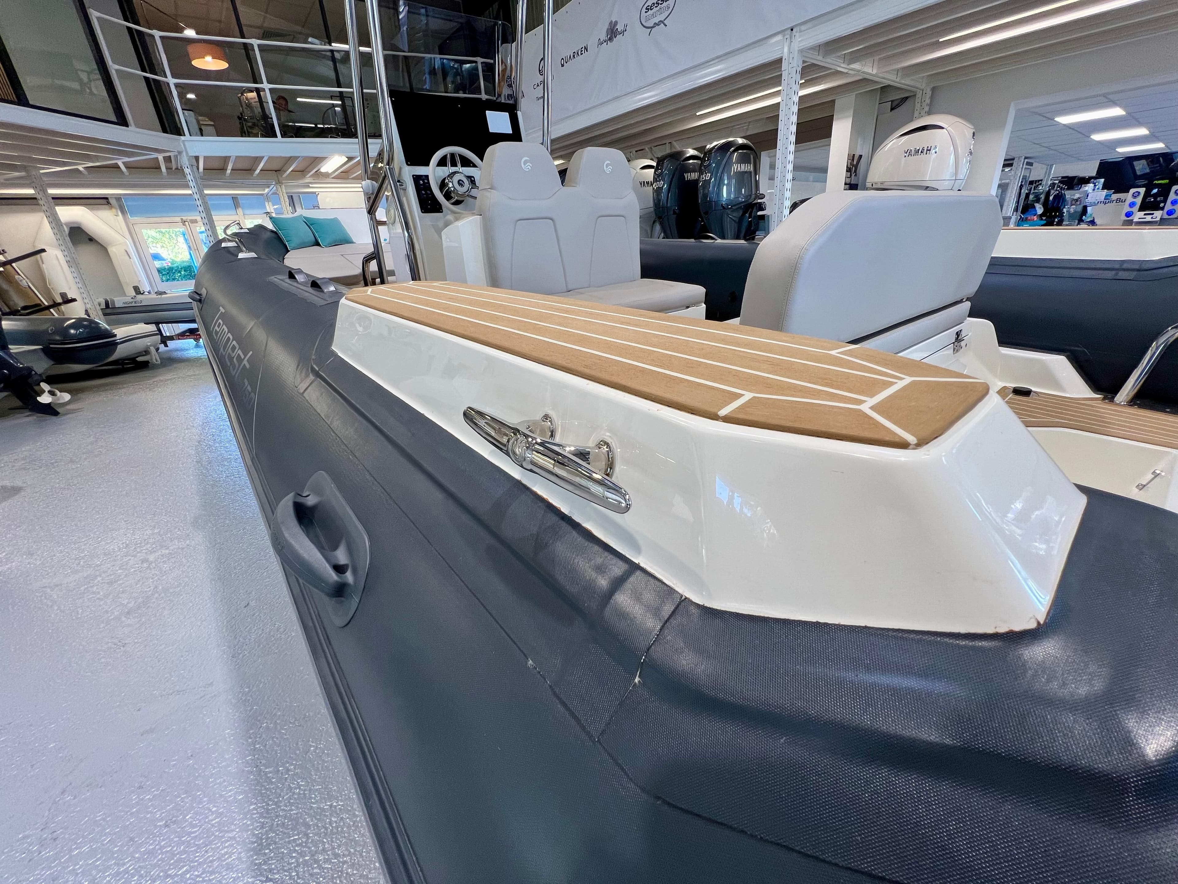 2023 Capelli Tempest 750 Luxe boat interior, showcasing seating and deck details in showroom.