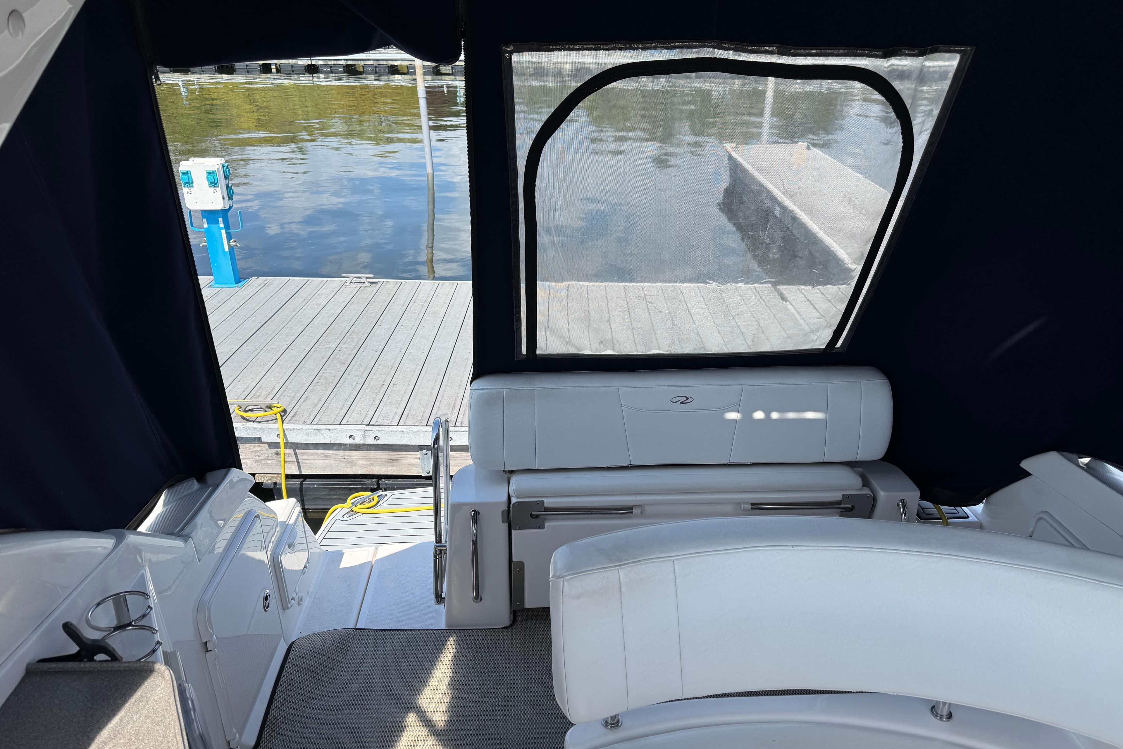 2007 Regal 3060 Window Express boat interior with dock view through rear window.