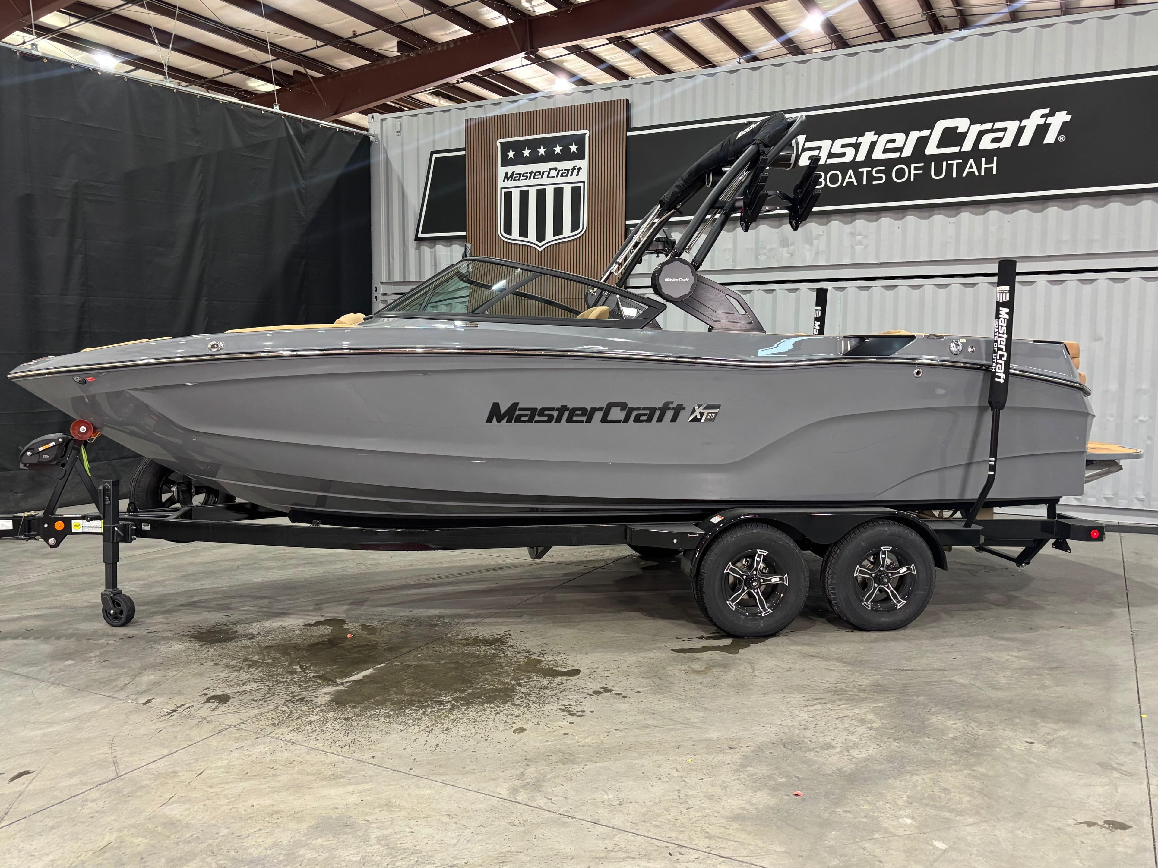2025 MasterCraft XT23 boat displayed indoors on a trailer.
