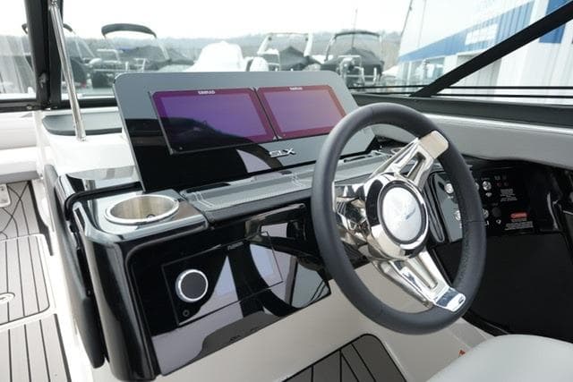 2026 Sea Ray SLX 260 boat dashboard with modern steering wheel and dual screens.