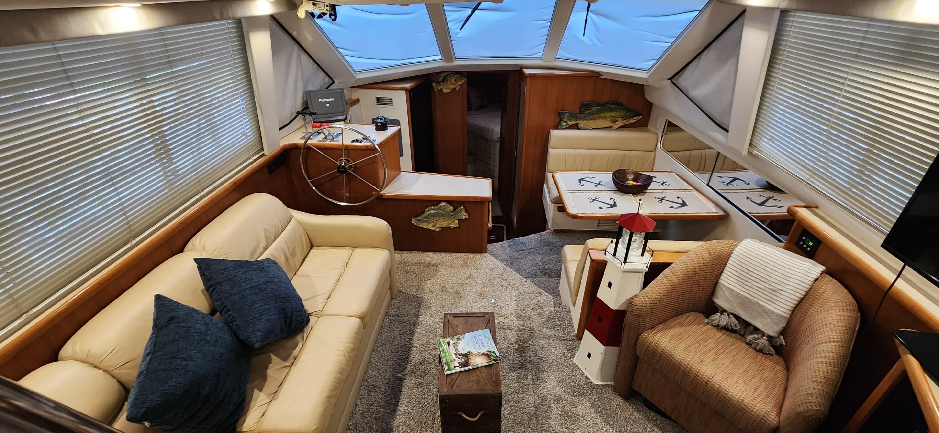 Interior of 1998 Carver 355 Aft Cabin Motor Yacht with cozy seating and nautical decor.
