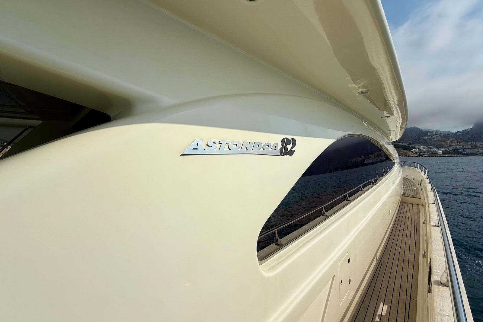 2003 Astondoa 82' GLX yacht side view with ocean and coastline in background.