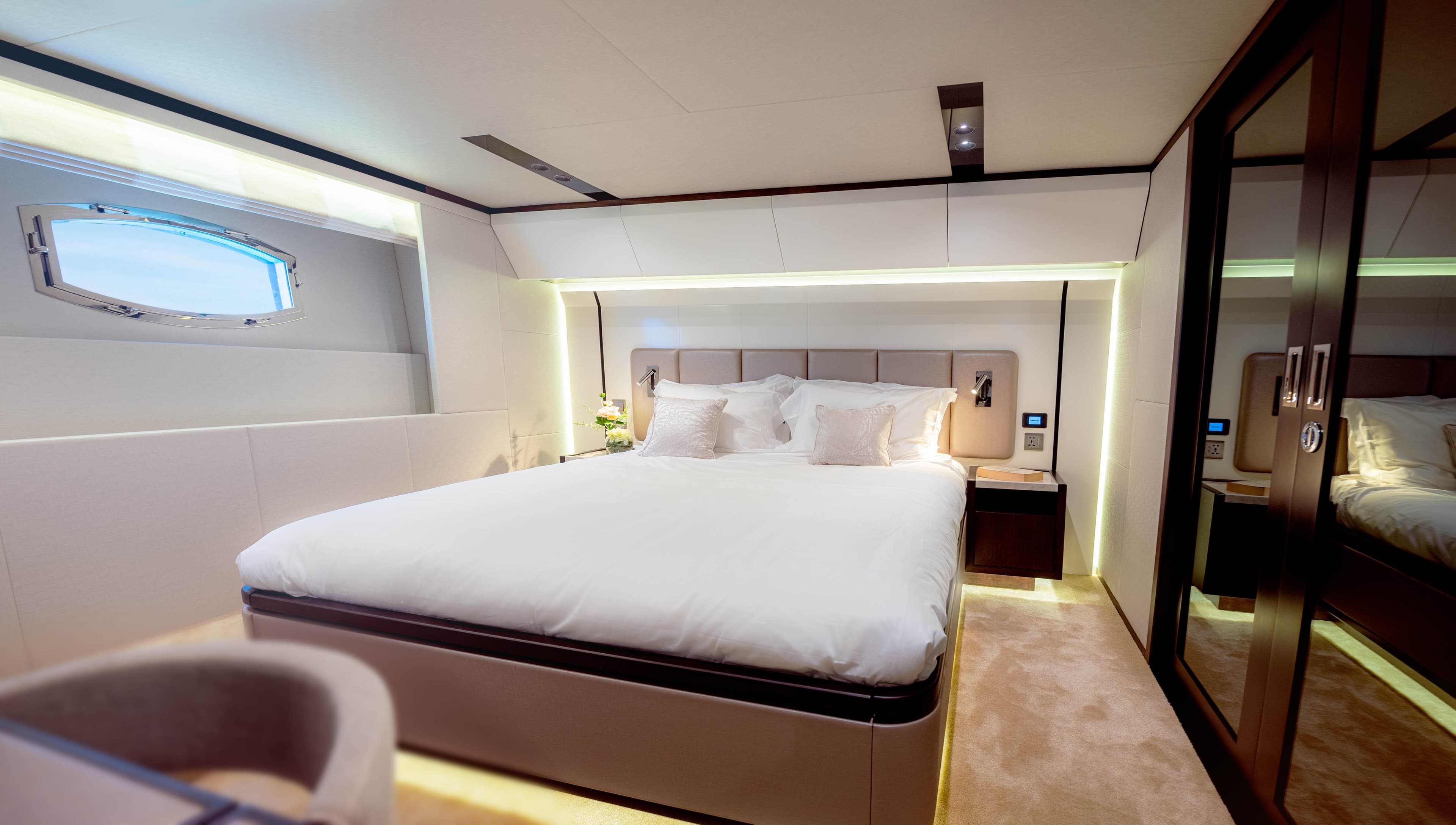 Luxurious bedroom interior of 2025 Majesty 62M yacht with modern design and ambient lighting.