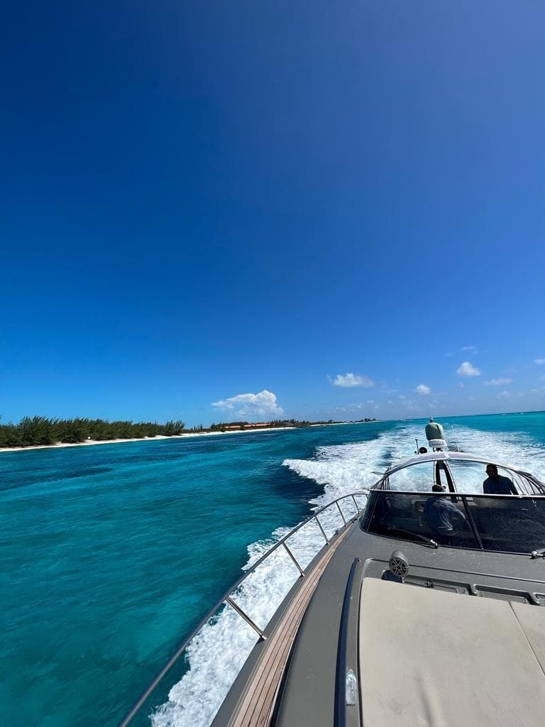 Luxury Riva Rivale 2012 yacht cruising on turquoise waters under clear blue sky.