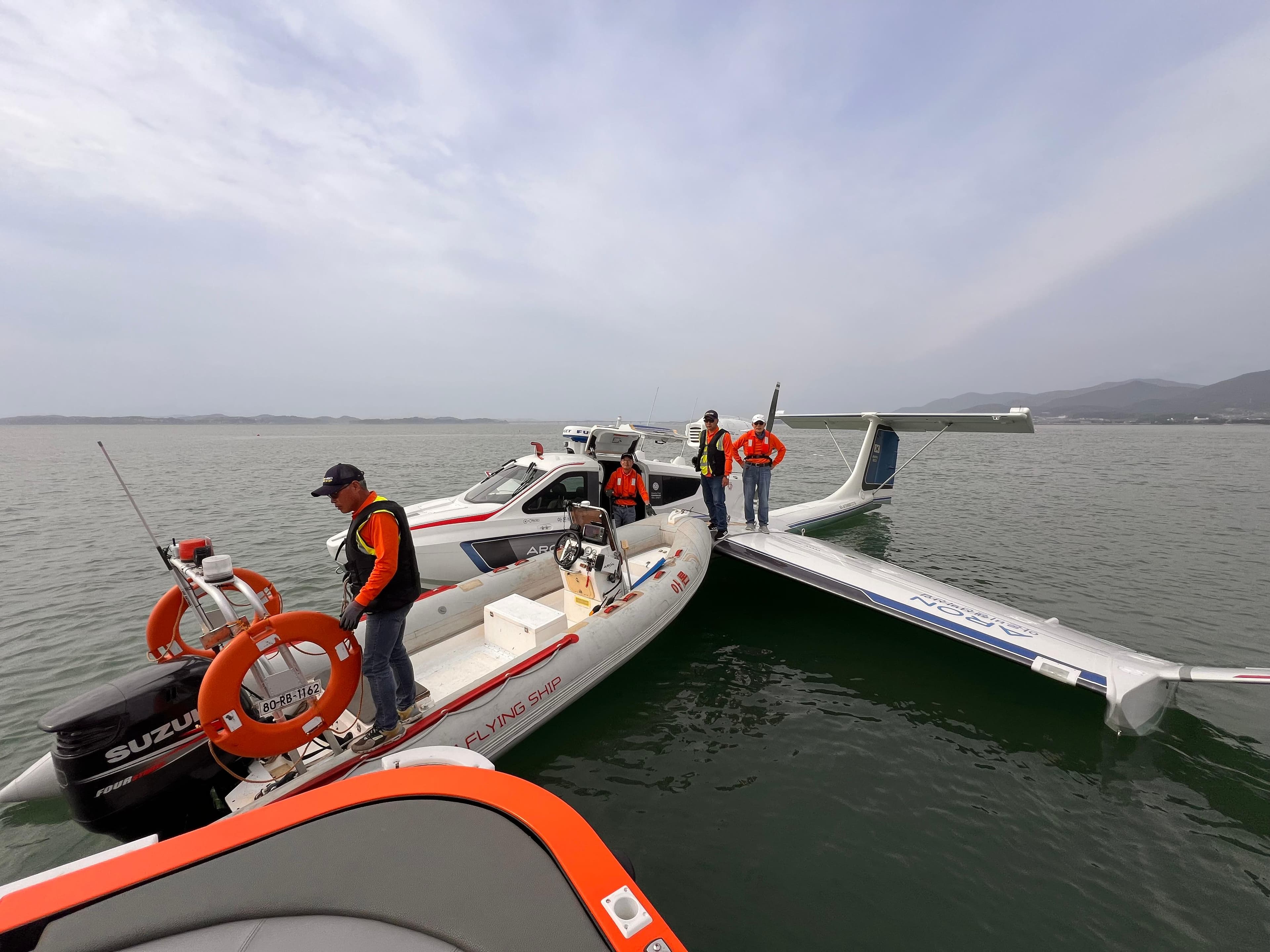 Rescue team near Aron M 80 seaplane on water, 2025 model.