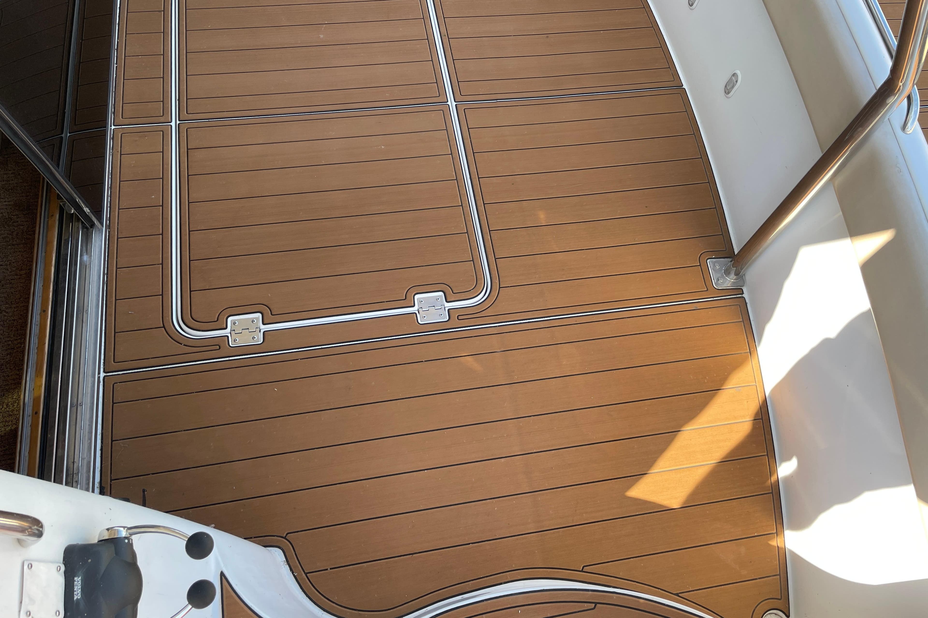 Teak deck of 2002 Carver 570 Voyager Pilothouse yacht, featuring sleek design and stainless steel accents.