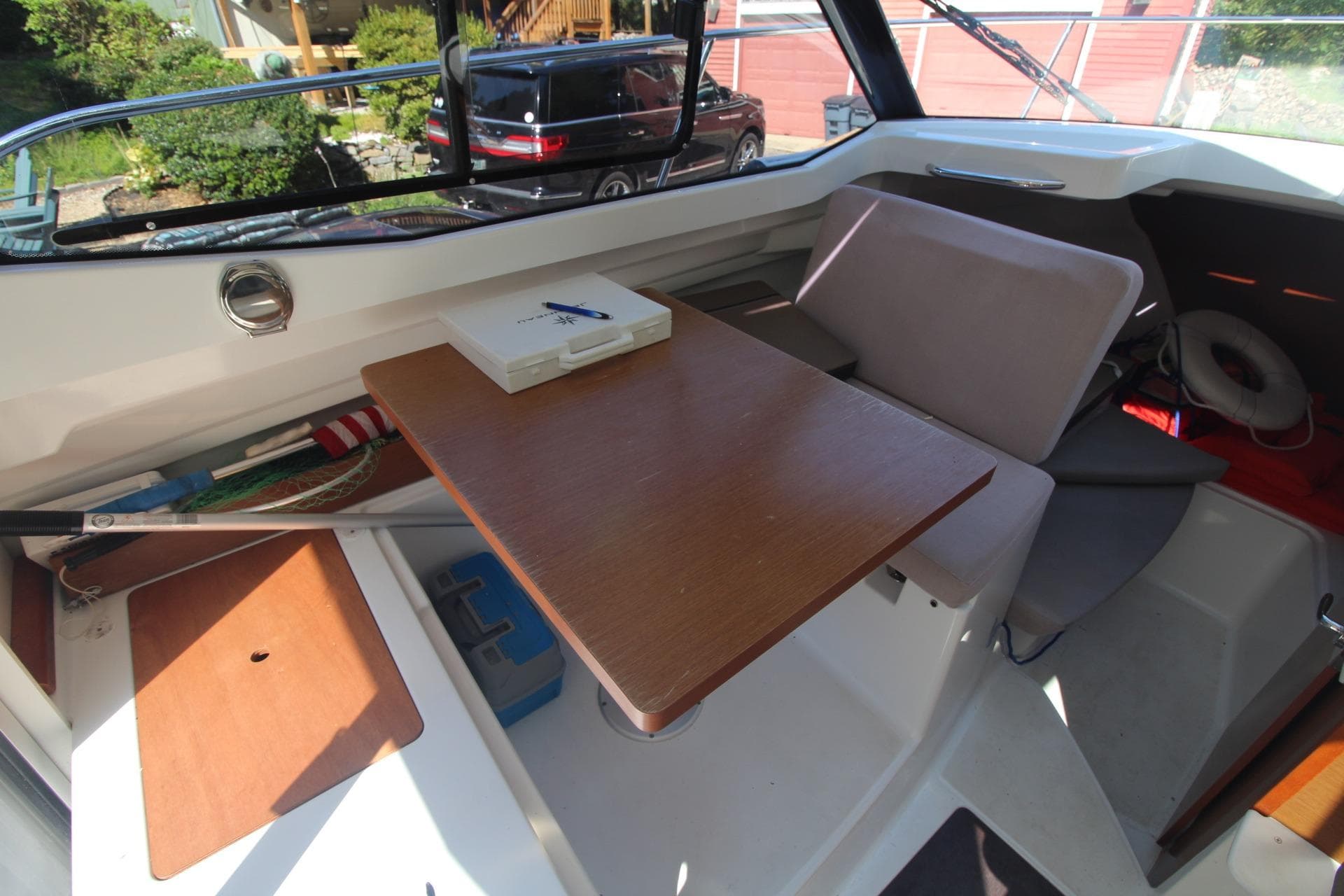 Interior of 2017 Jeanneau NC Sport 695 boat with table and seating area.