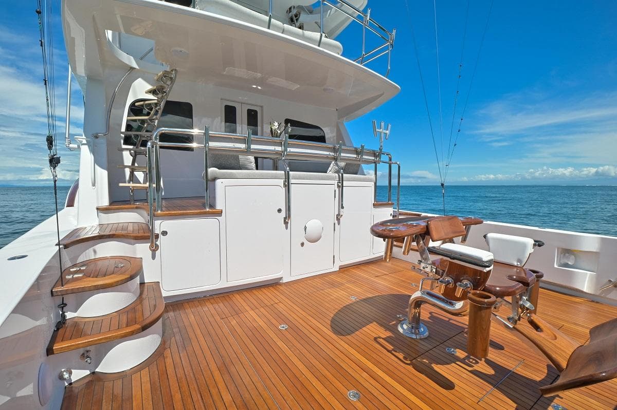 Luxurious 2013 Sea Force IX 94' Sportfisher yacht deck with wooden flooring and fishing chairs.