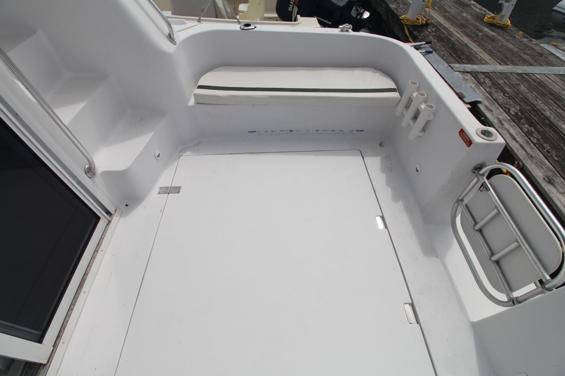 1999 Mainship 31 Sedan Bridge boat deck with white finish and railing.