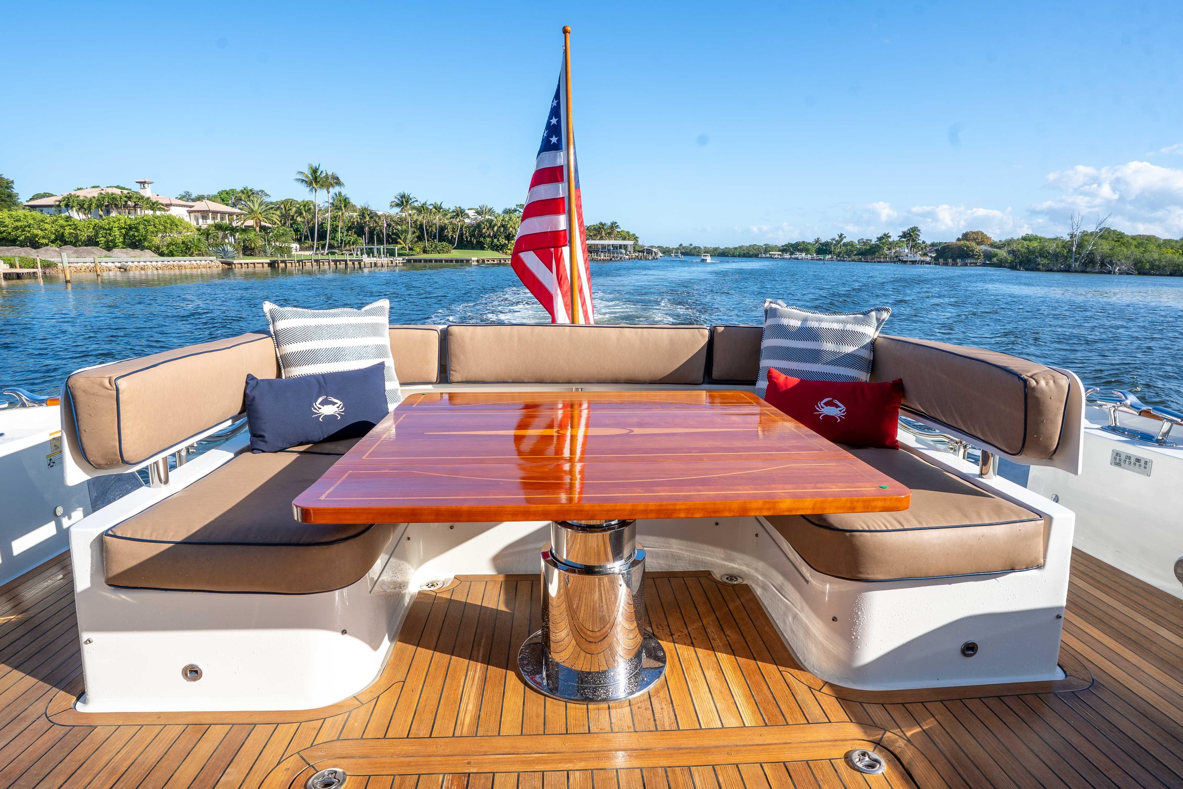 Luxury seating area on 2018 Sabre 66 Dirigo yacht with American flag.