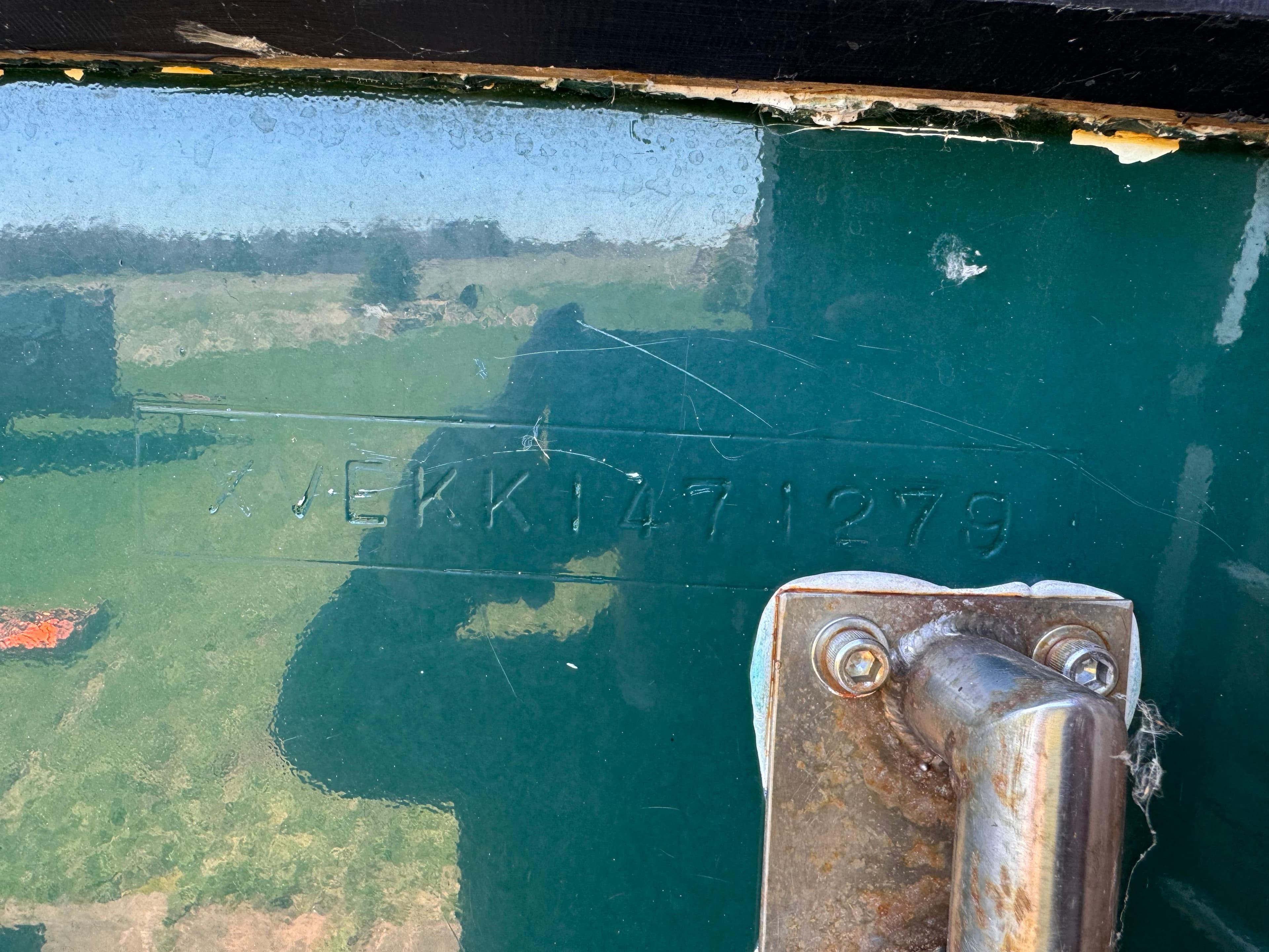 1979 Hyundai Roughwater 29 boat hull with visible serial number and metal fitting.