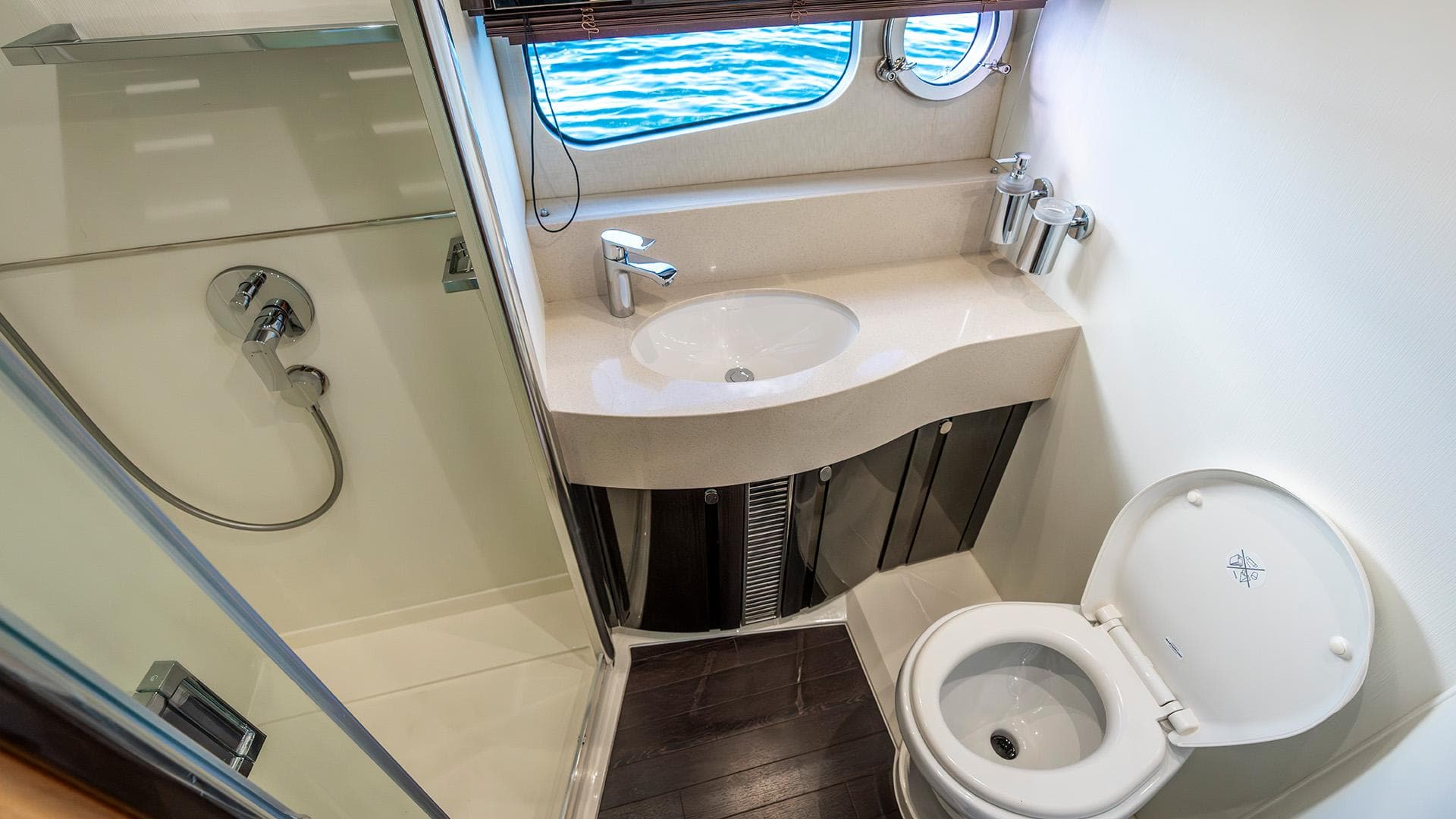 Luxurious bathroom on 2014 Sunseeker Manhattan 55 yacht with shower, sink, and toilet.