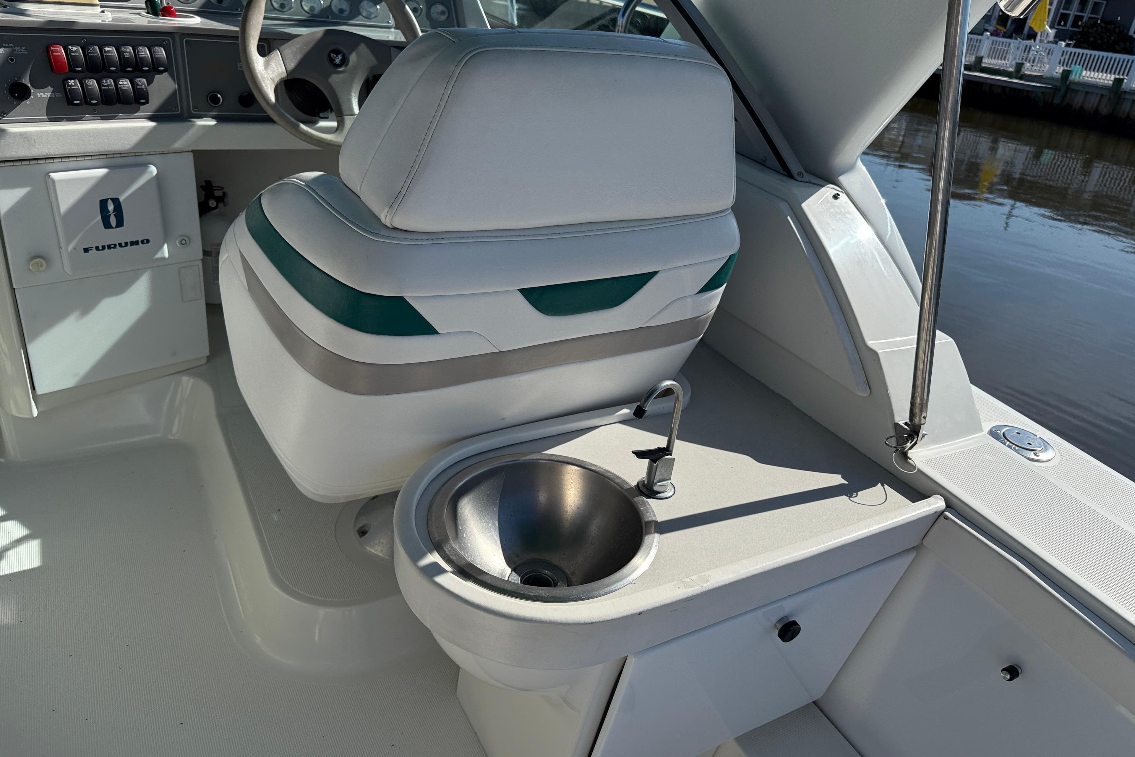 1998 Formula 34 Performance Cruiser cockpit with steering, seat, and sink.