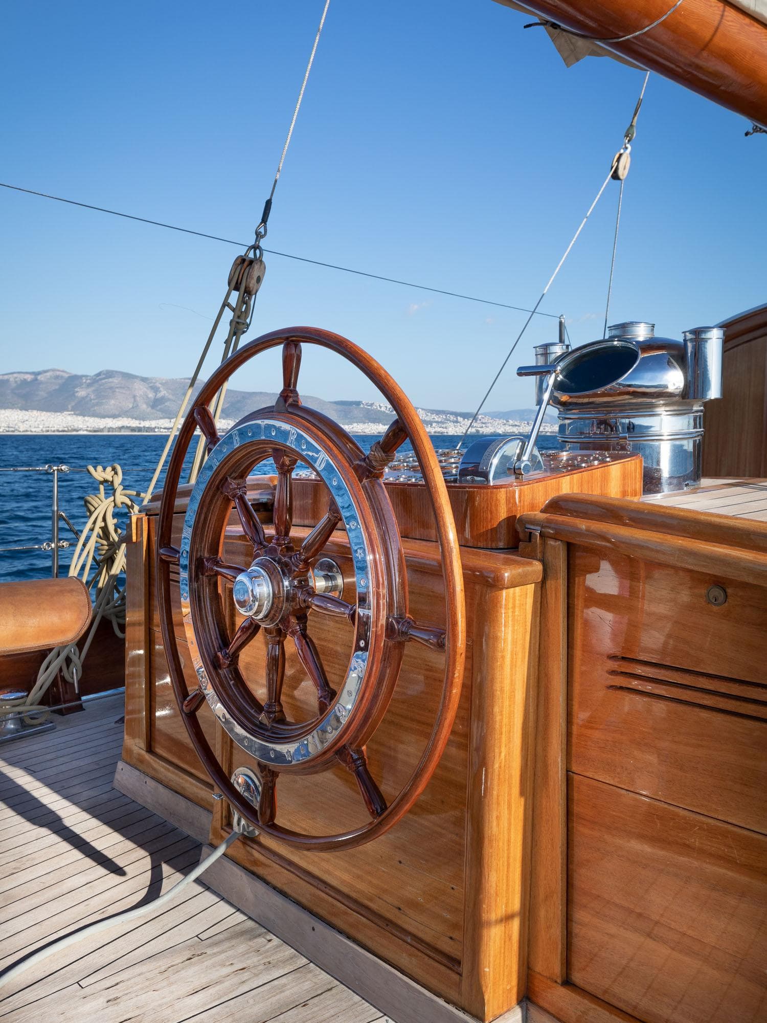 Wooden helm of 1931 Schooner Navals de Normandie on open sea.