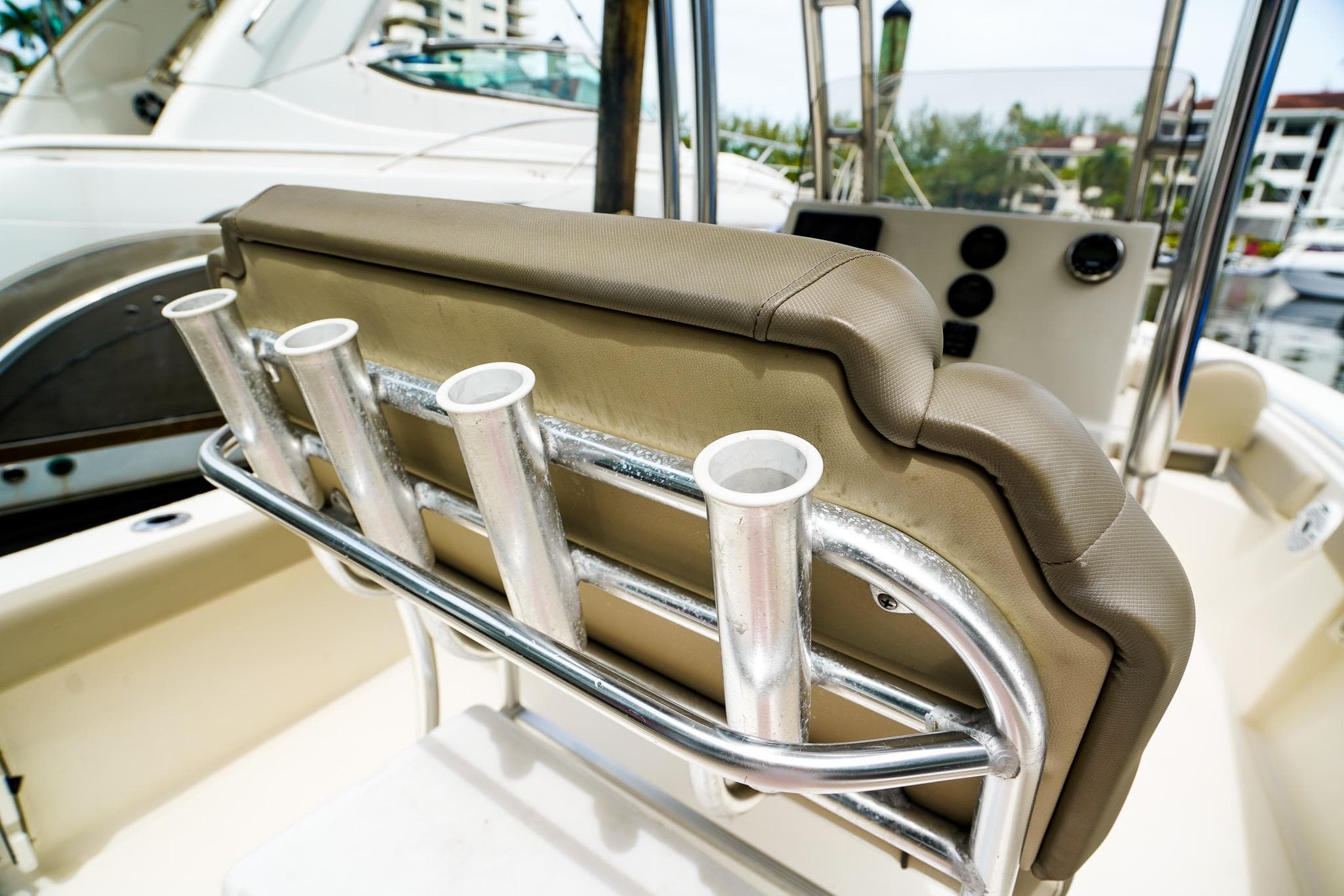 2022 Key West 219 FS boat seat with rod holders in a marina setting.