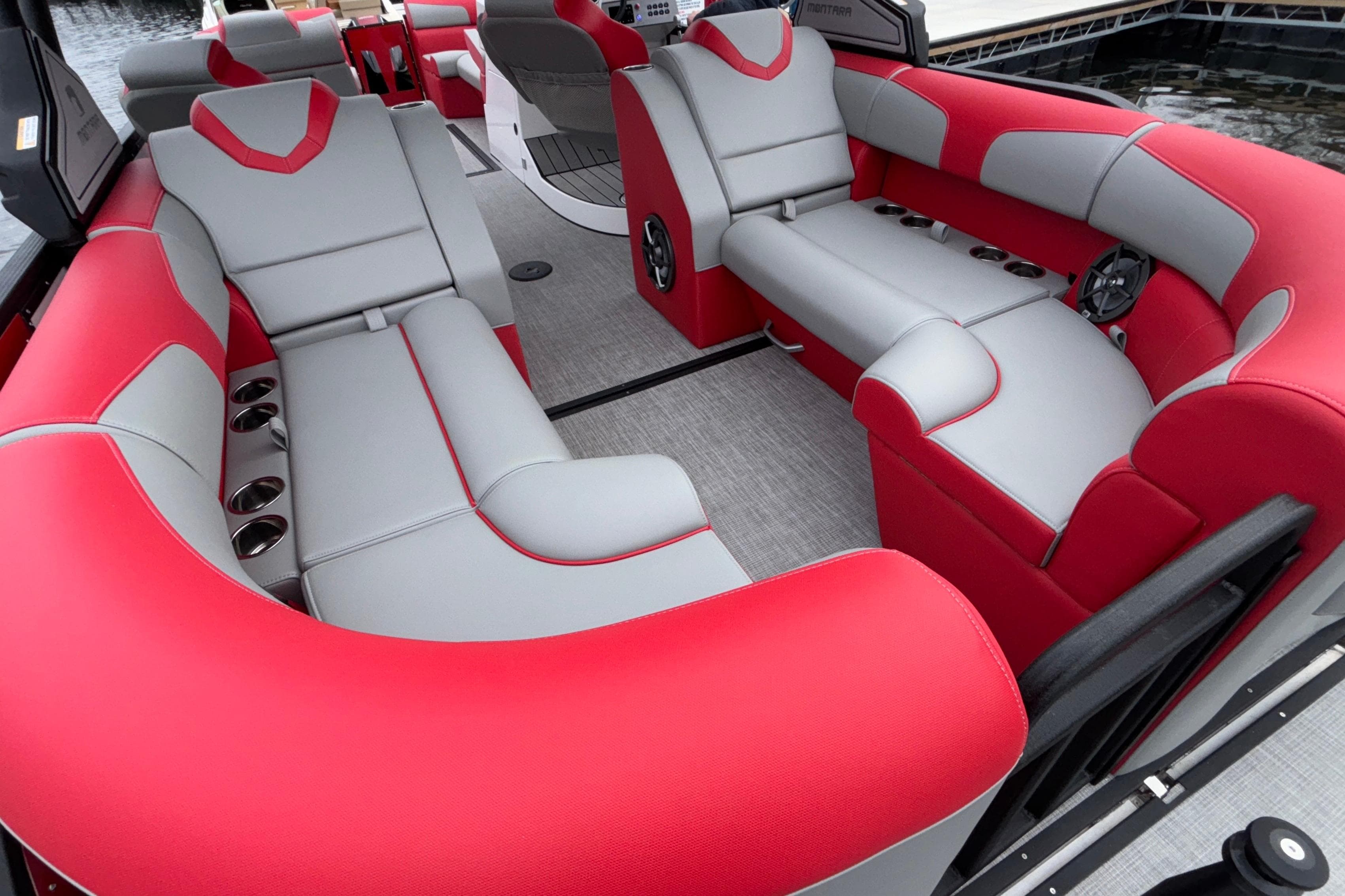 2025 Montara 25 Surf Boss boat interior with red and gray seating, cup holders, and modern design.