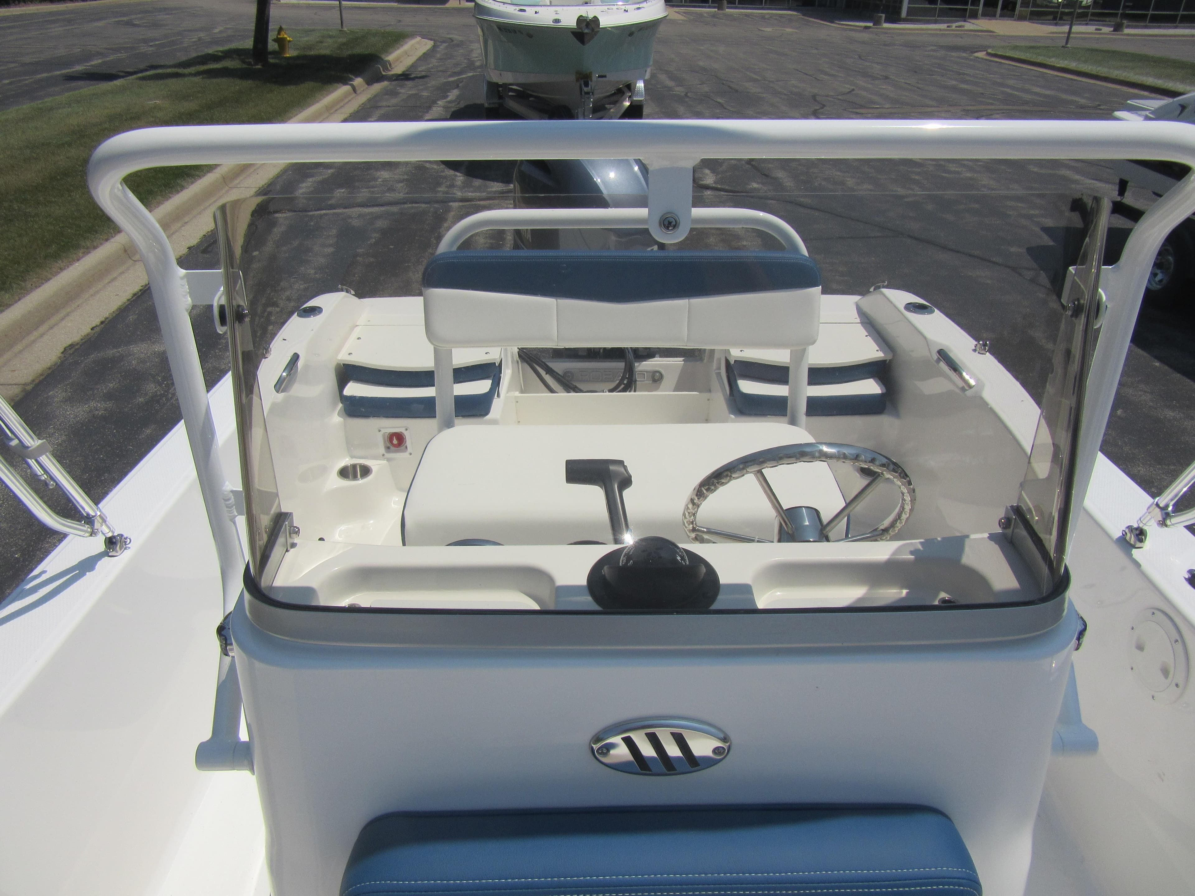 2025 Robalo R160 Center Console boat interior with steering wheel and seating.