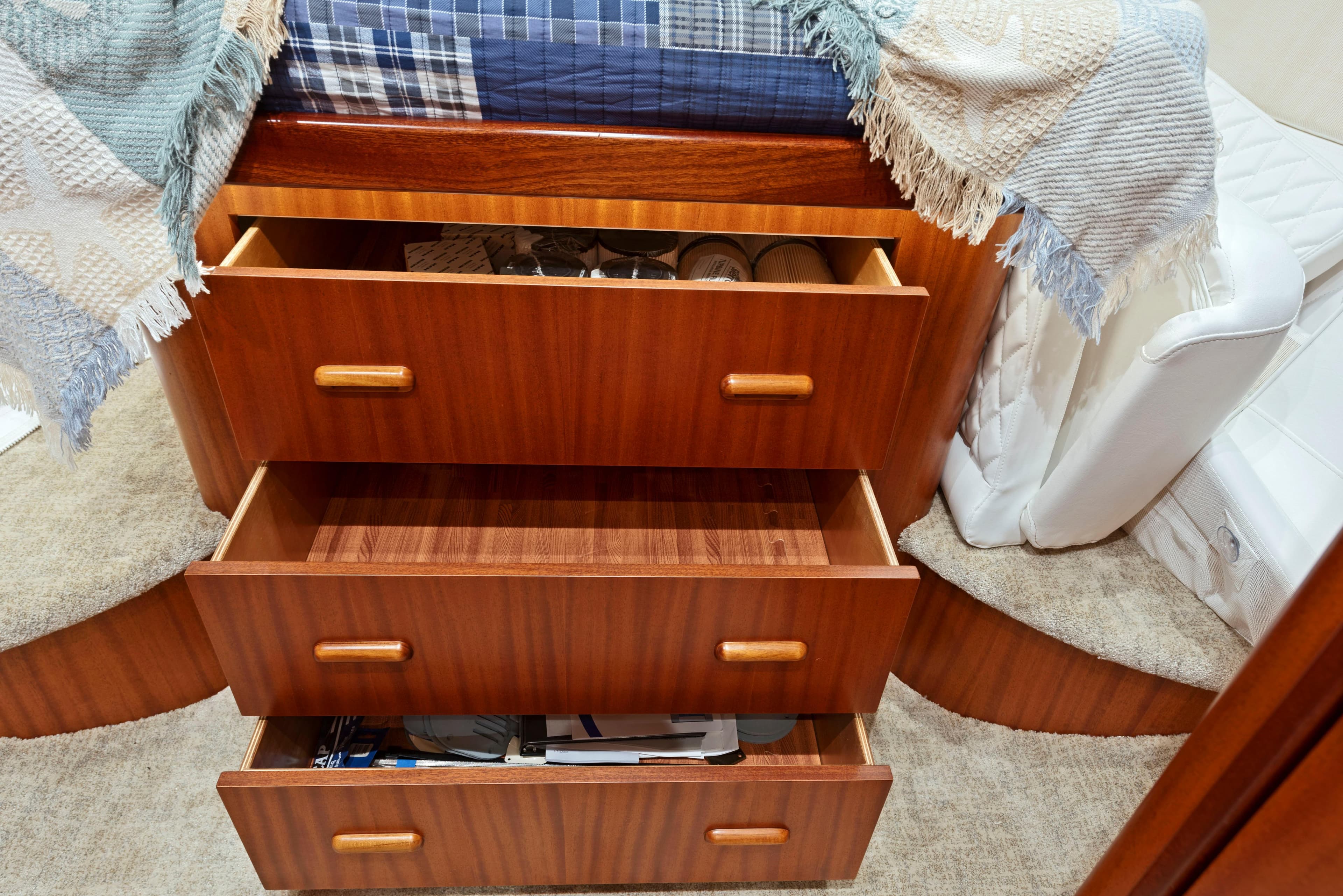 Wooden drawers in a 1963 Whiticar 54 Sportfisherman cabin, showcasing storage space.