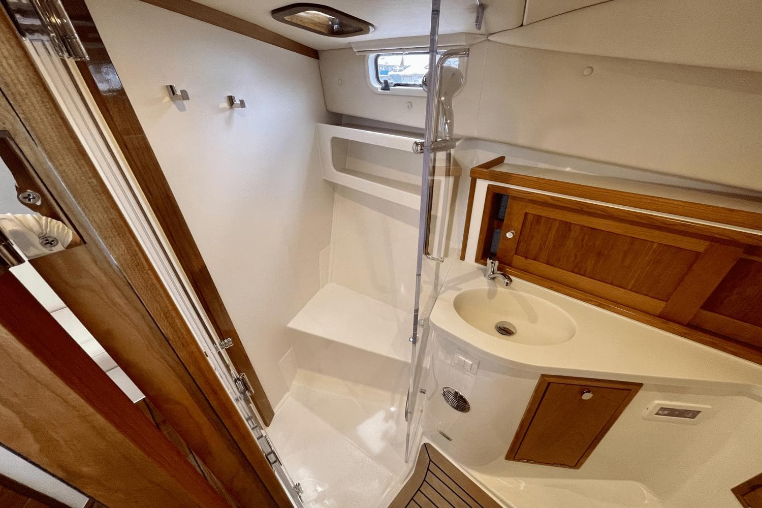 2024 MJM 4 yacht bathroom with wooden accents, shower, and sink.