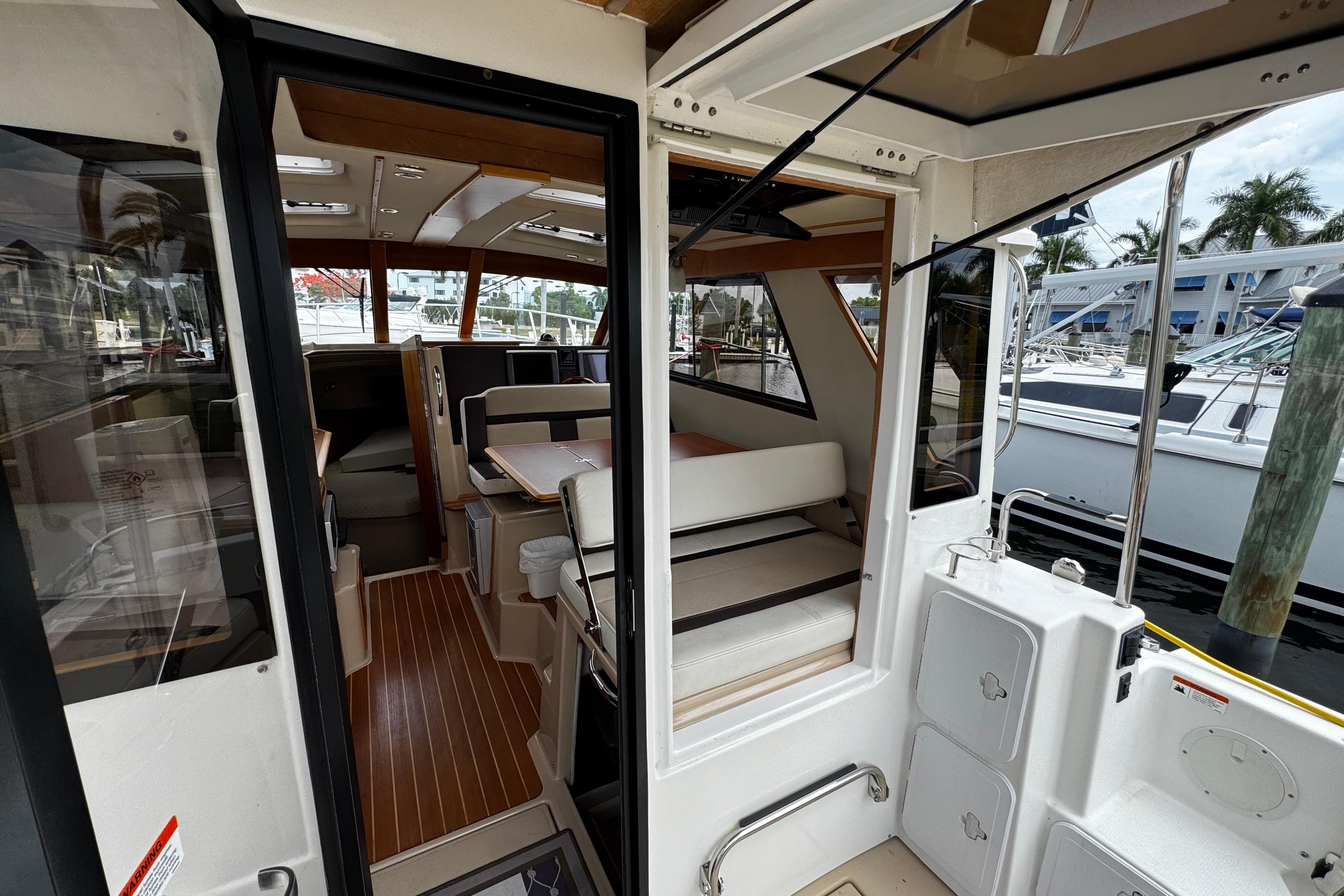 Interior view of a 2015 Cutwater 30 Sedan boat, showcasing seating and helm area.