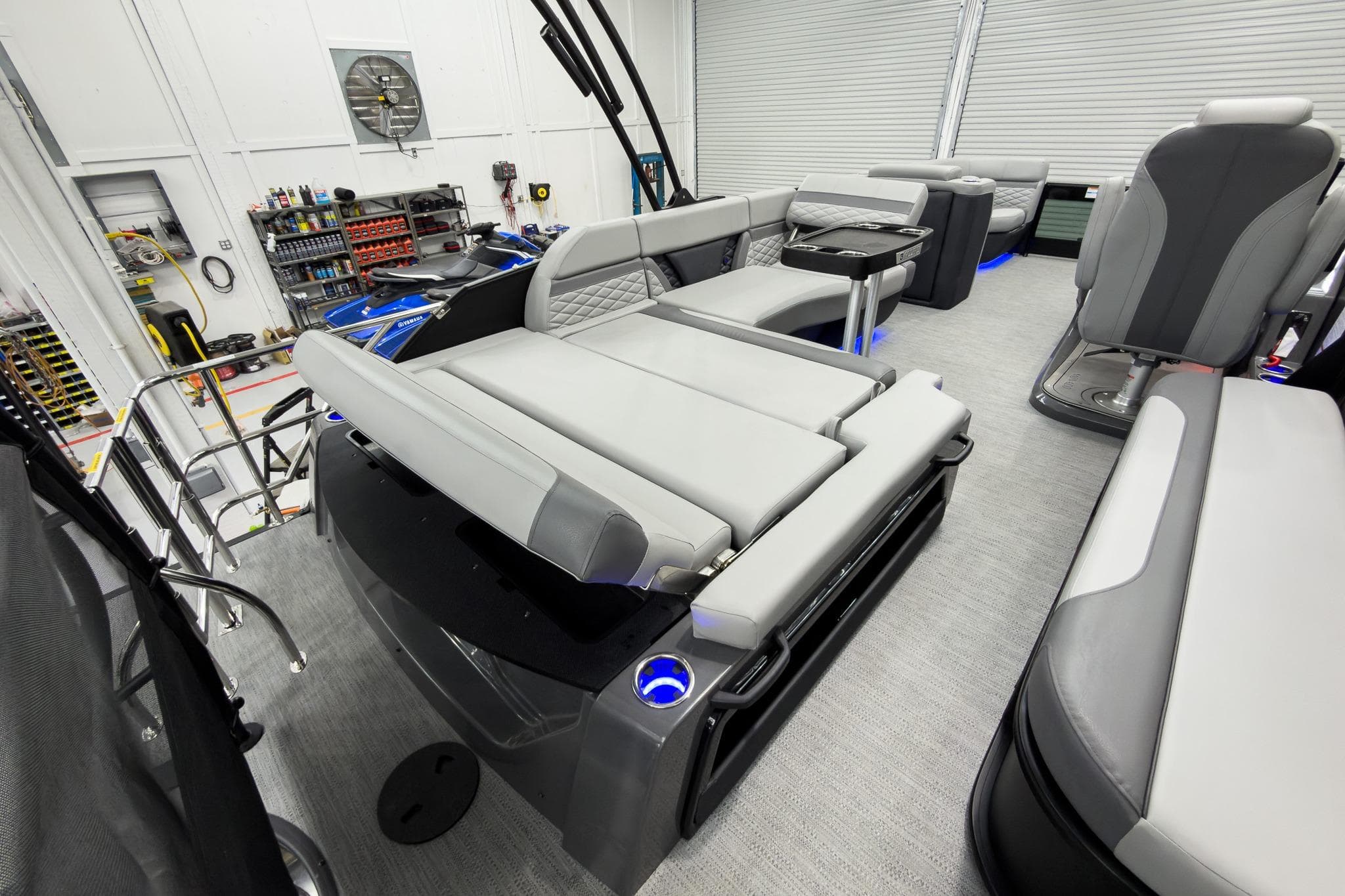 2026 Godfrey Monaco 23' Tritoon with luxurious seating and modern design in a showroom.