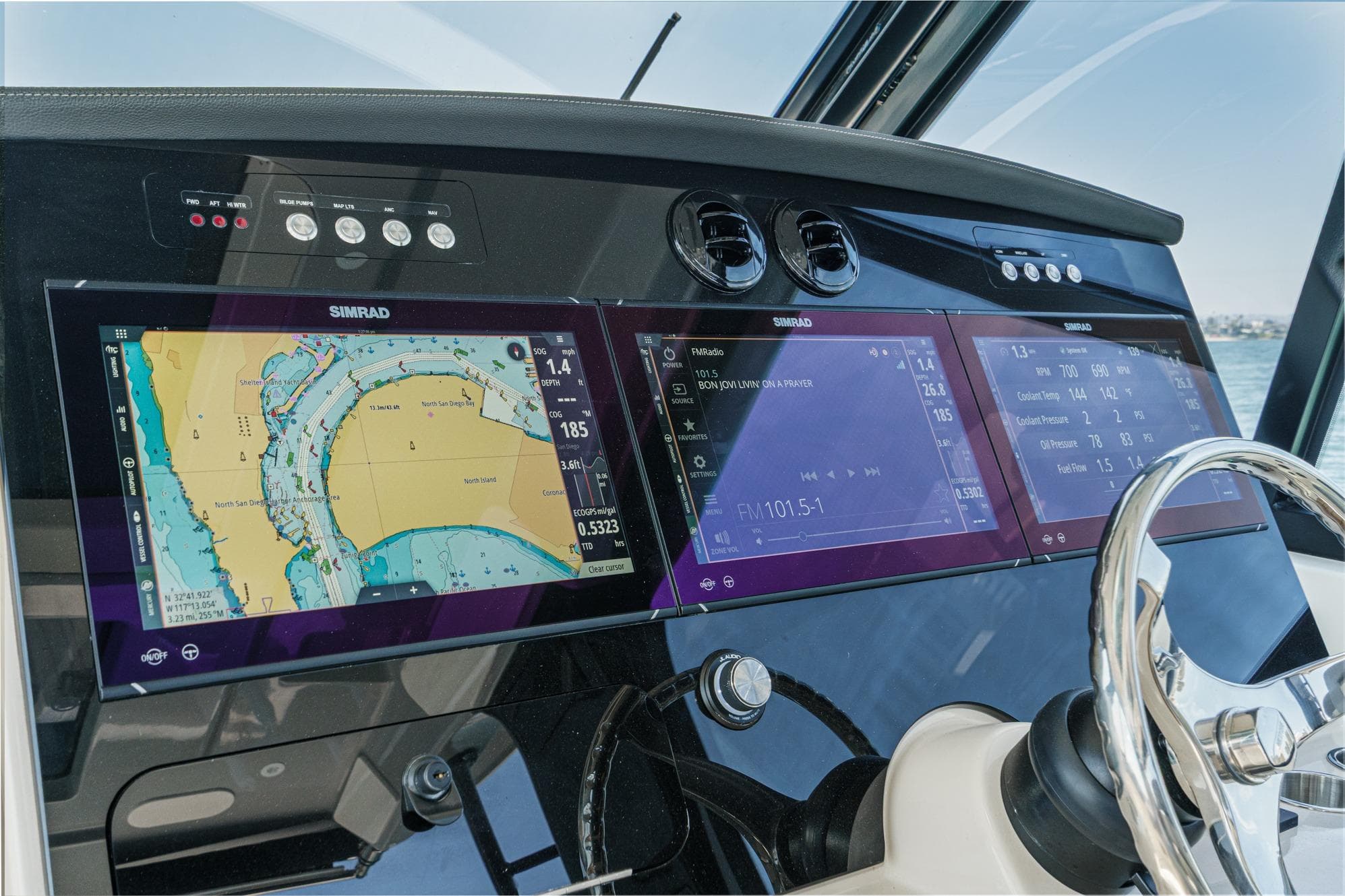 2024 Boston Whaler 380 Realm dashboard with Simrad navigation displays and steering wheel.