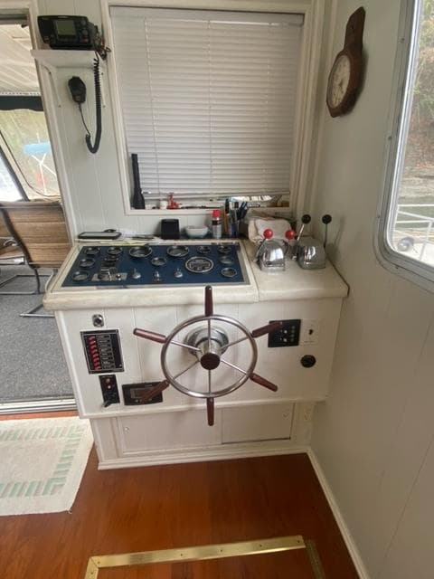 1985 Arc houseboat control panel with steering wheel and gauges.