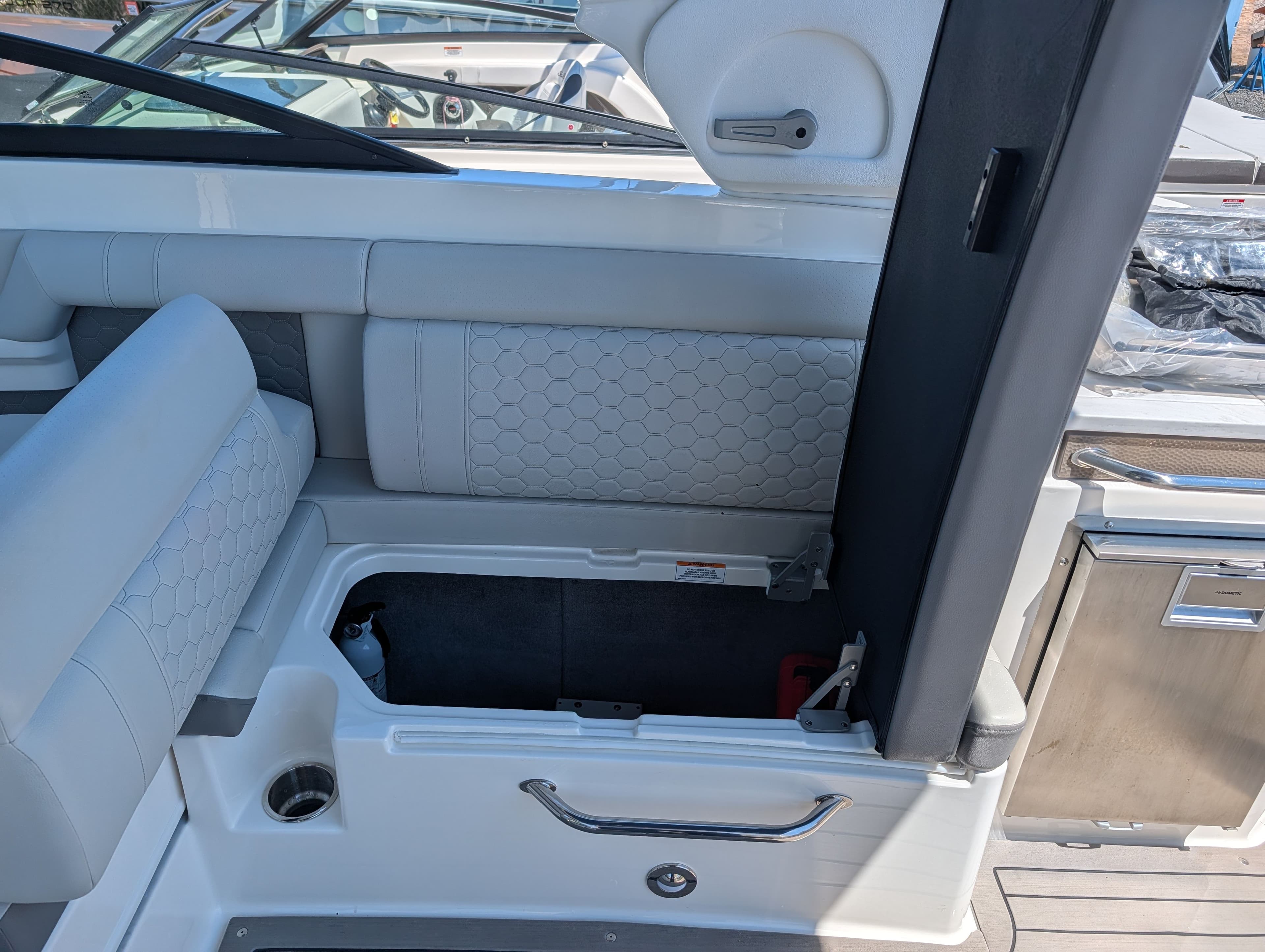 Interior of 2022 Sea Ray 290 SD OB with storage compartment.