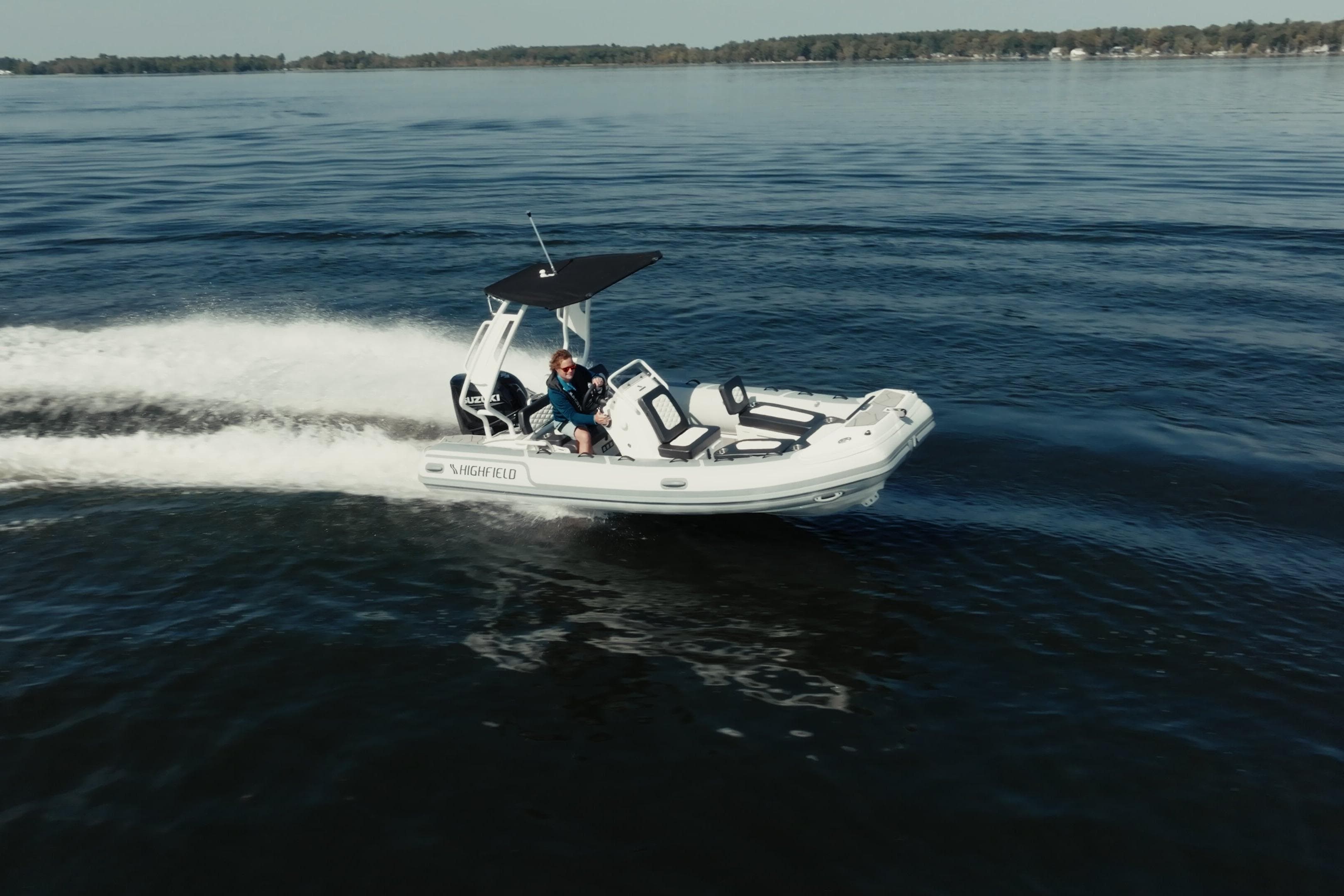 2026 Highfield Sport 520 boat cruising on a calm lake.