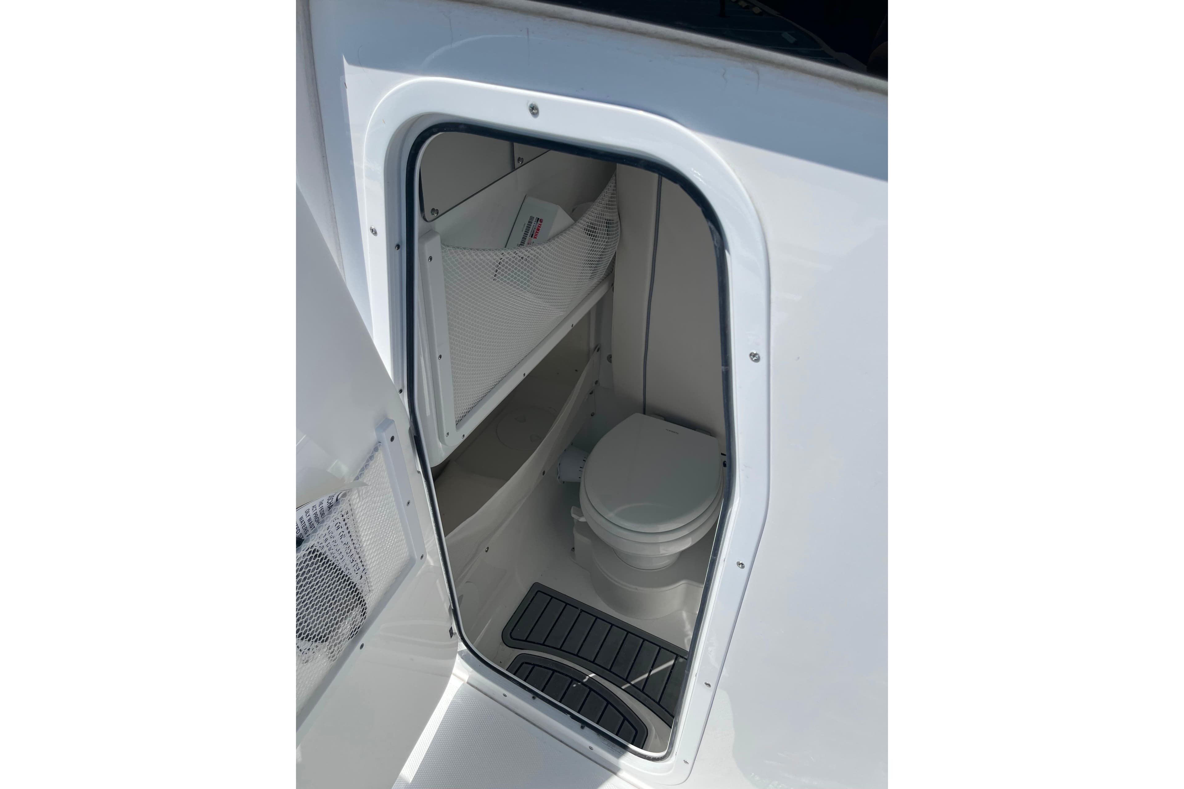 Interior view of 2026 Sea Hunt Ultra 275 Coffin Box boat's compact bathroom.