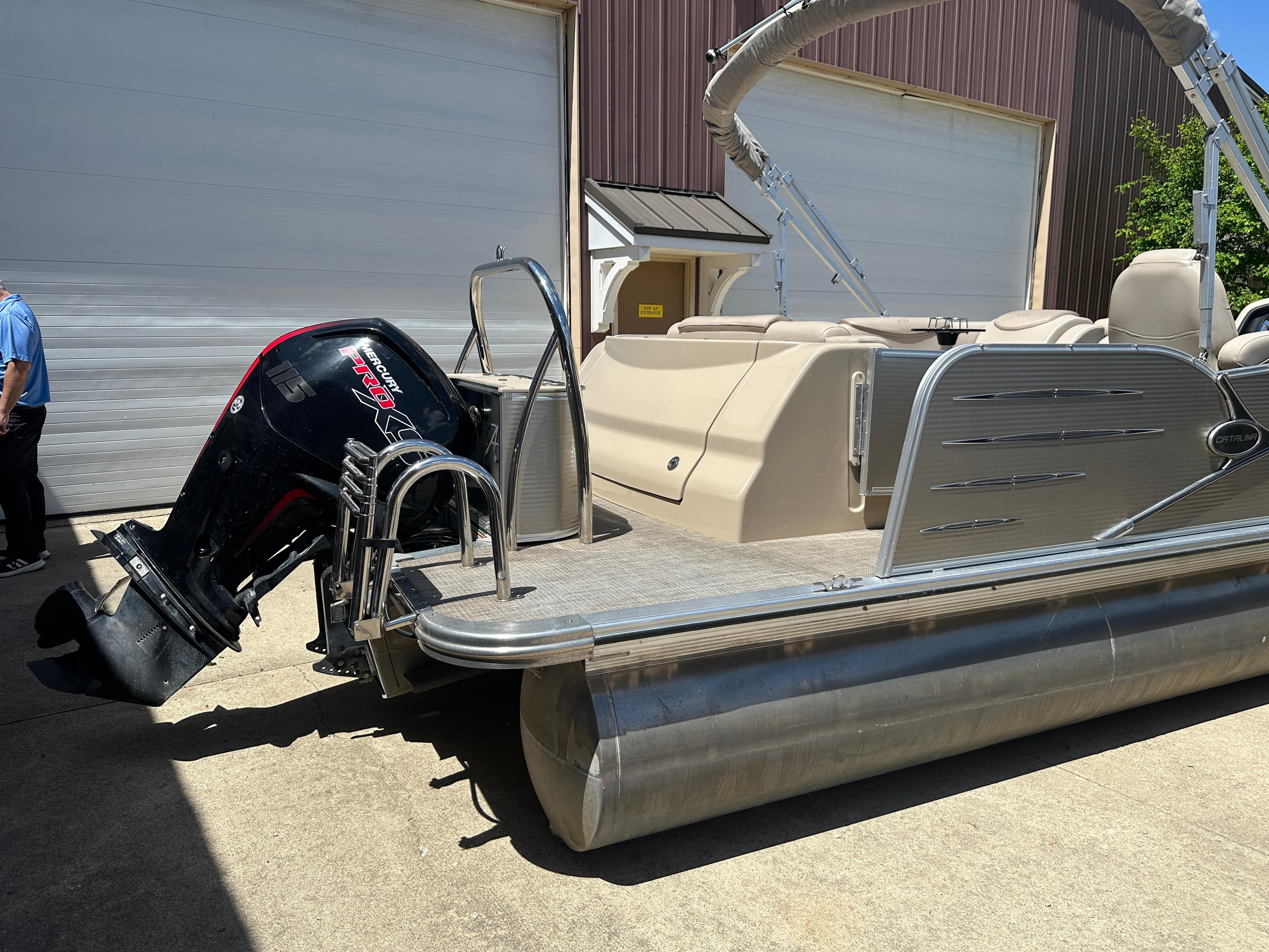 2018 Avalon Catalina Cruise 25' pontoon boat with outboard motor, parked near a garage.