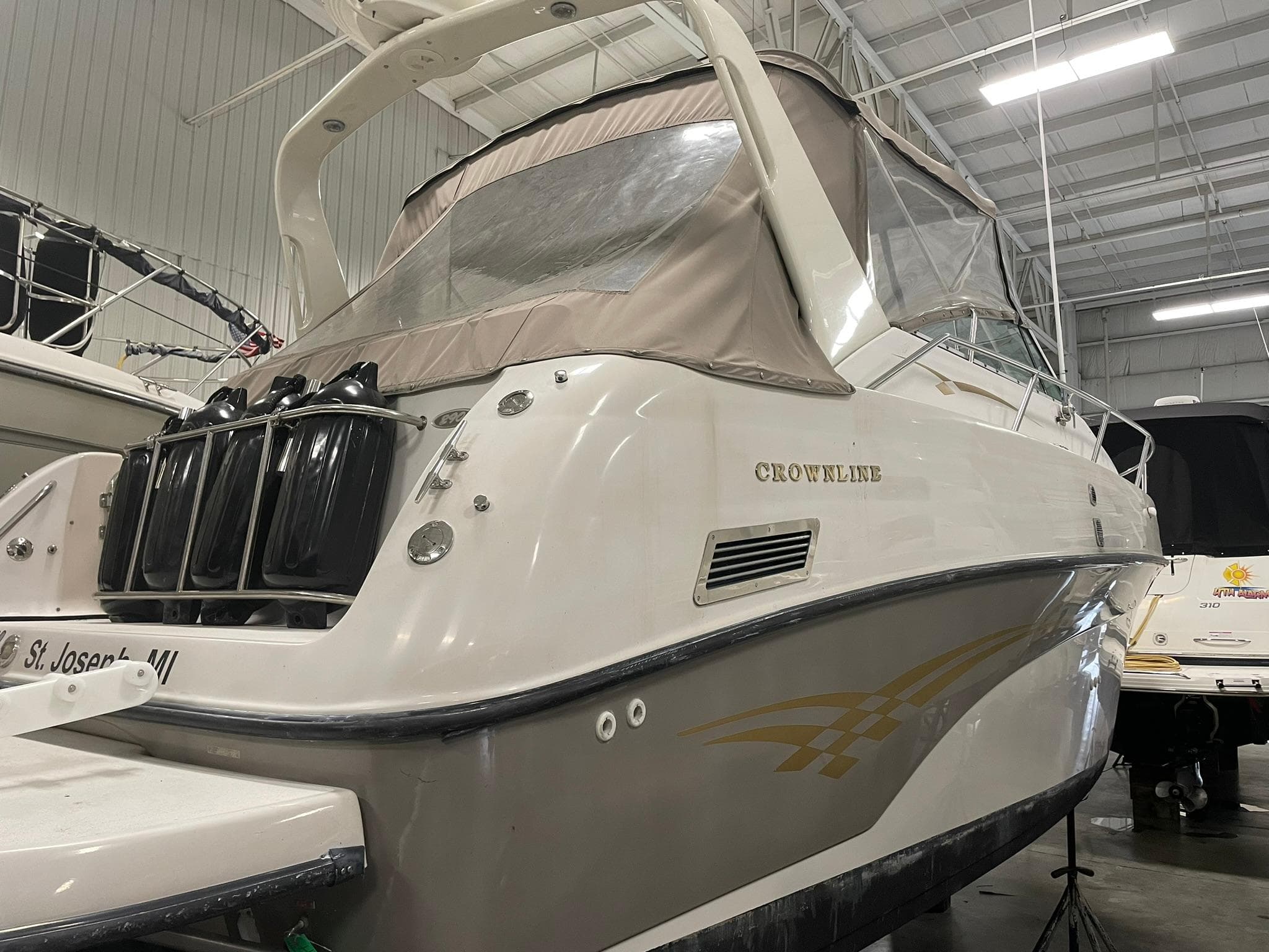 2000 Crownline 290 CR boat in indoor storage, rear view.