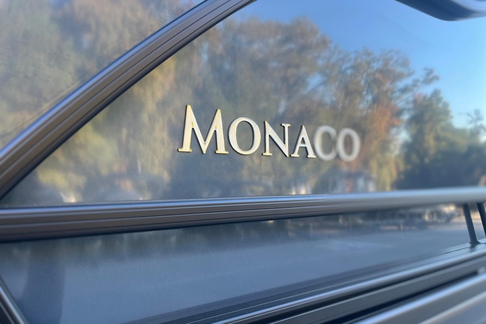 Close-up of 2026 Godfrey Monaco 235 SFL logo on sleek exterior.