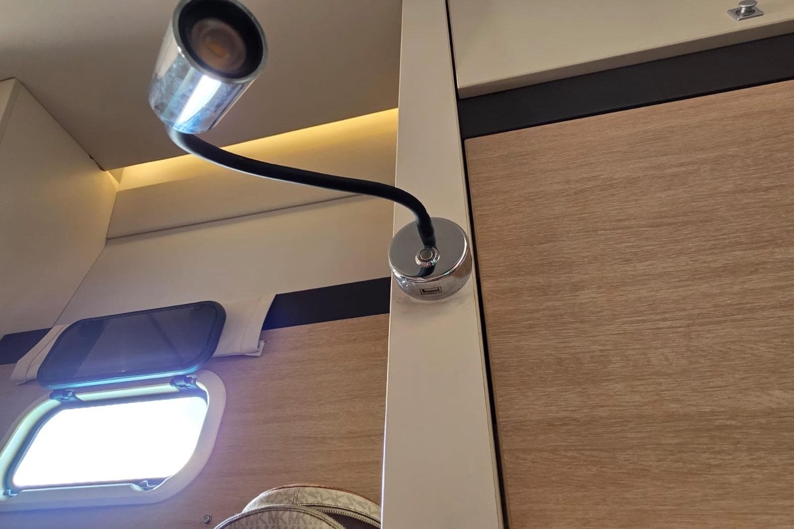 Interior of a 2016 Bali 4.5 yacht with a flexible reading light and window.