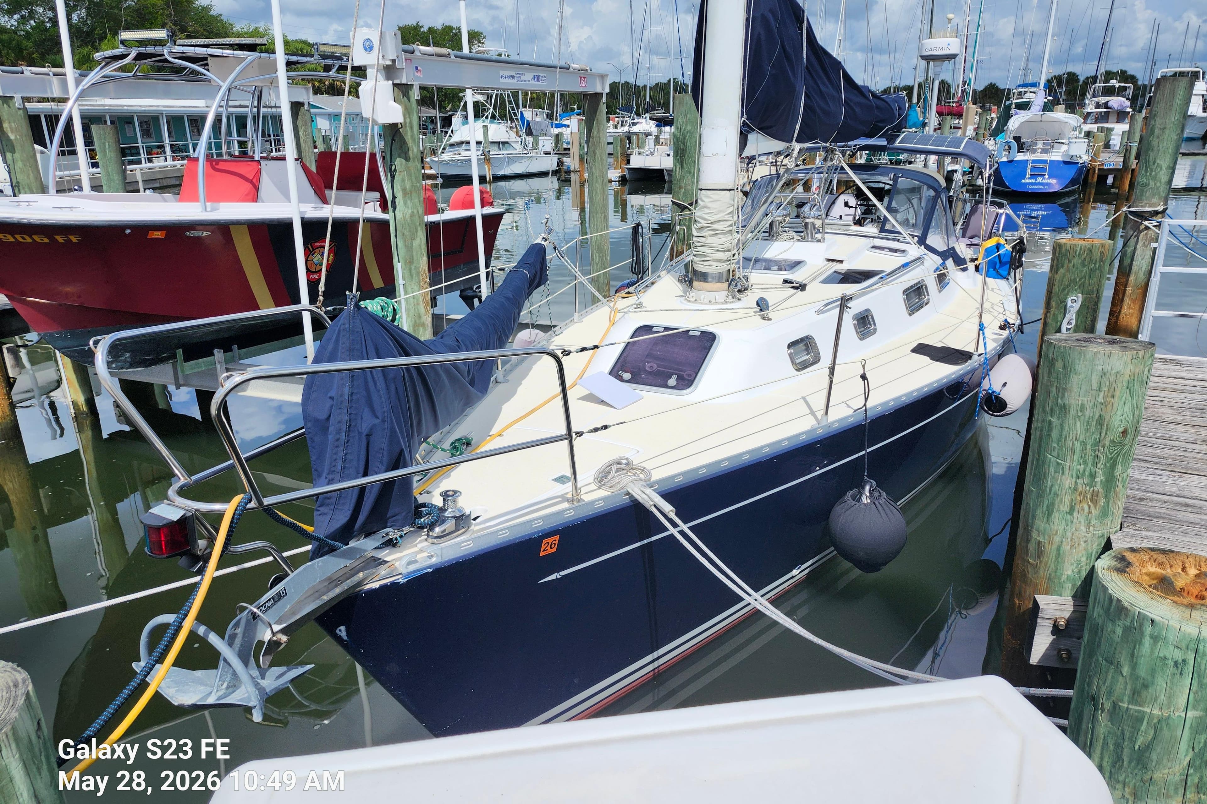 Sailboat Freedom 35, 1995 model, docked at marina with other boats.