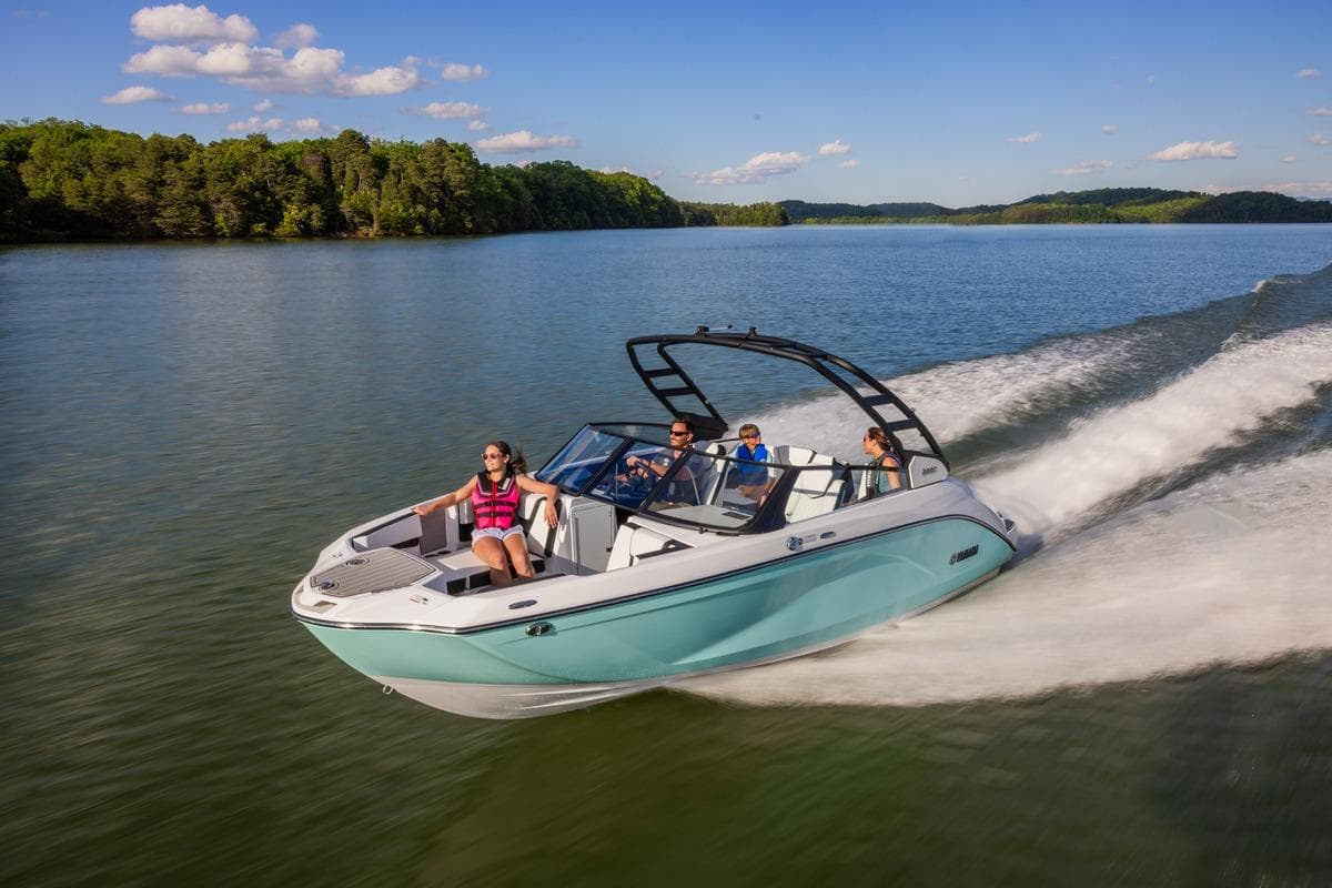 2026 Yamaha Boats 222S cruising on a scenic lake with passengers enjoying the ride.