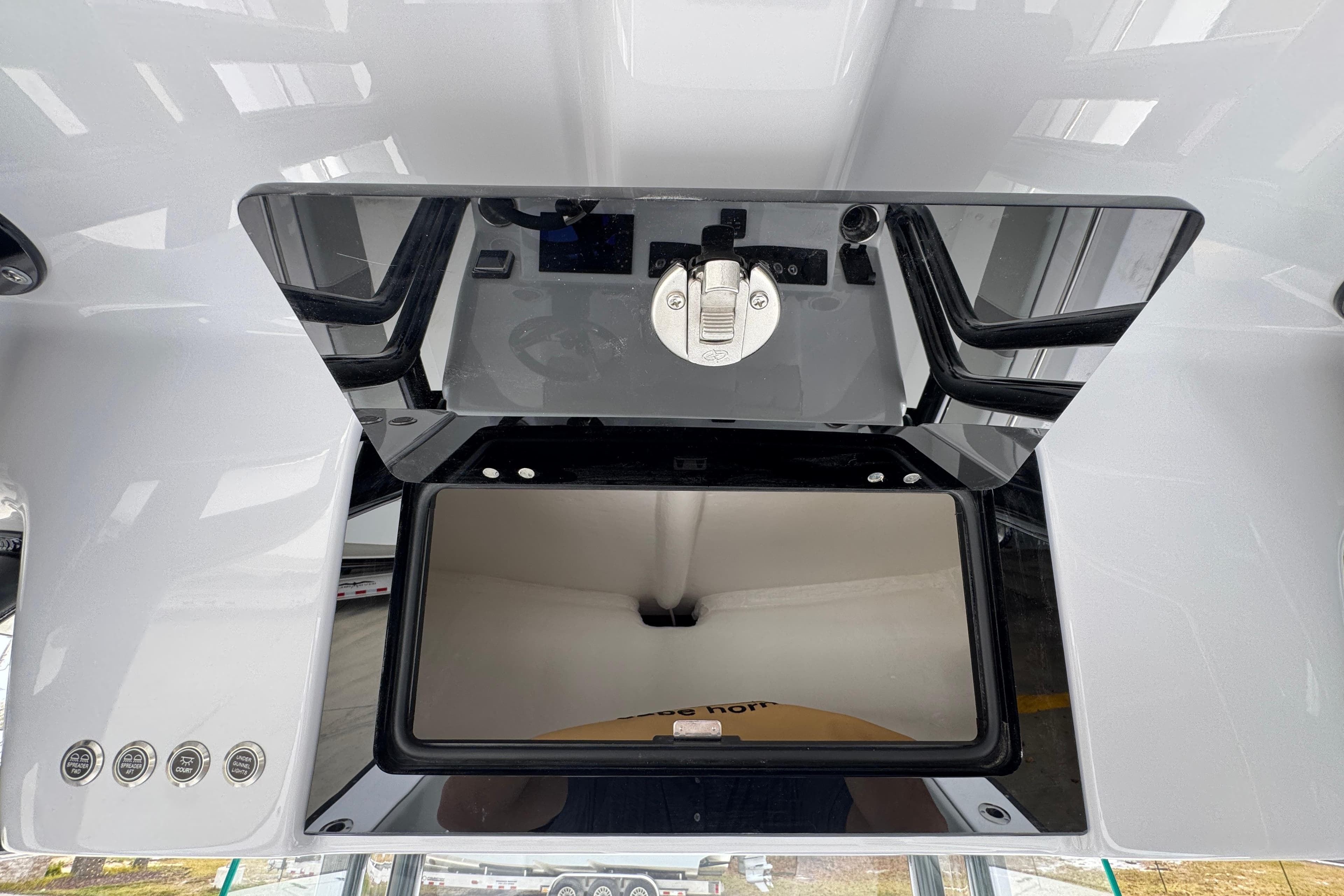 2026 Cape Horn 32 XS boat console with storage compartment and control panel.