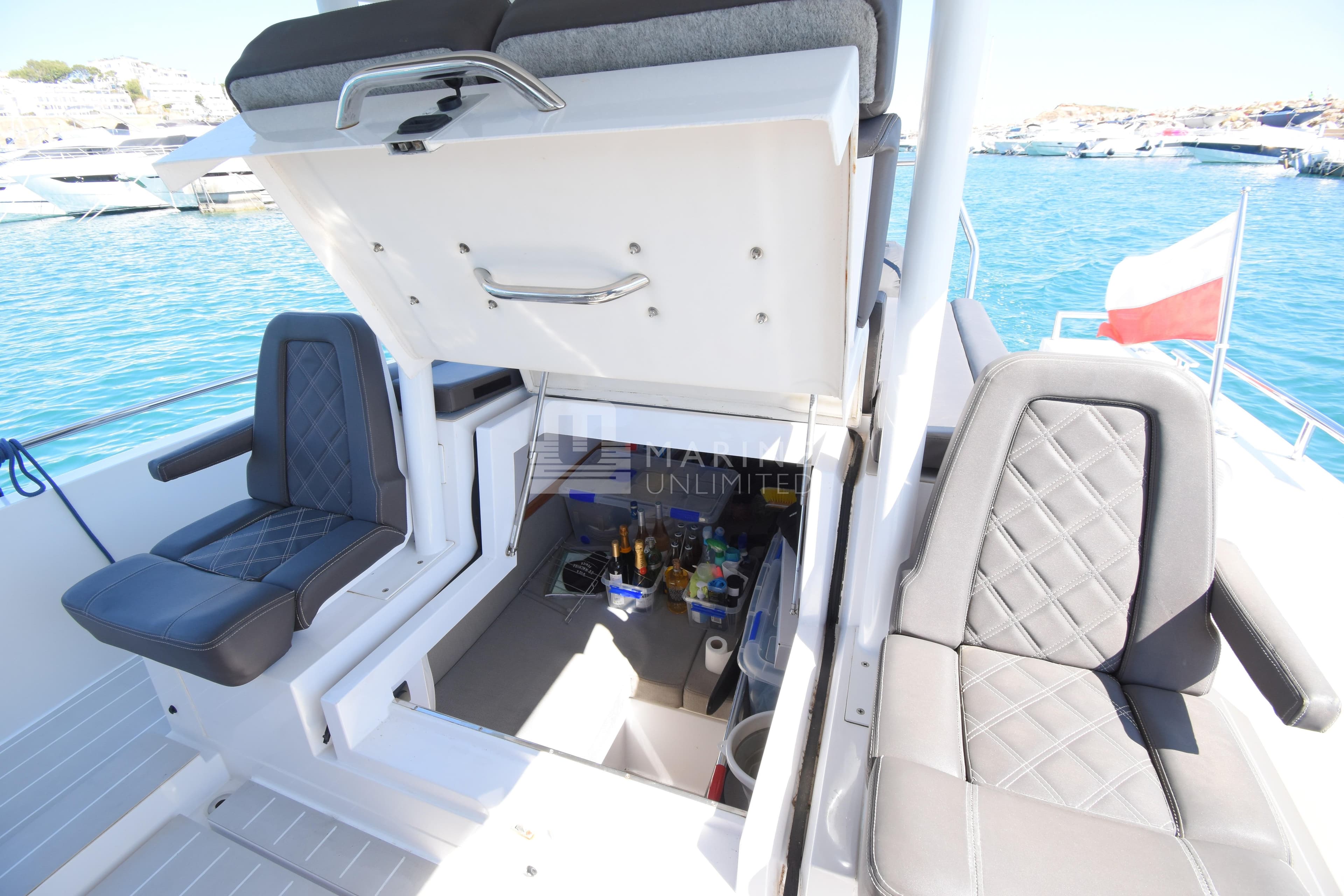 2016 Axopar 37 Sun-Top boat interior with open storage compartment and seating.